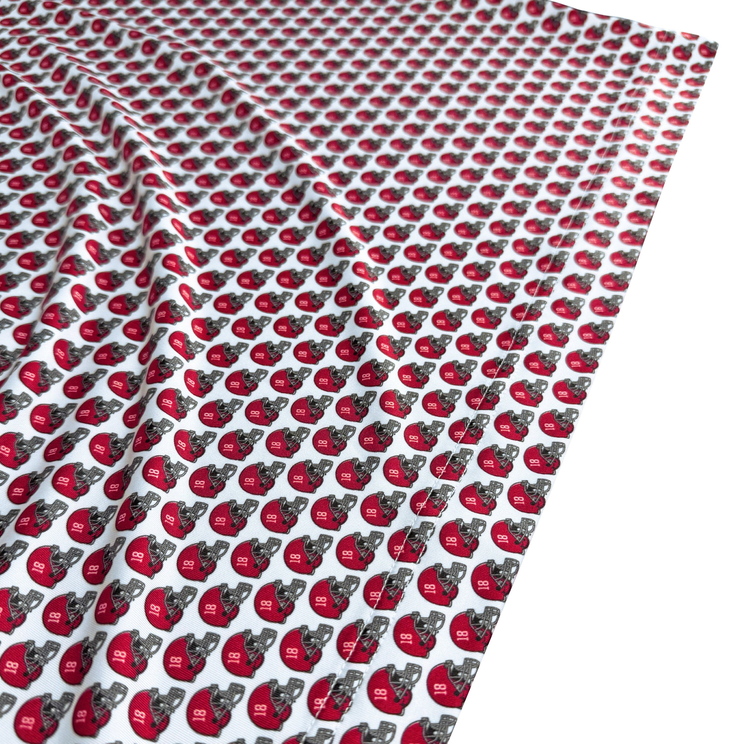 Patterned fabric with red and gray shapes on a white background