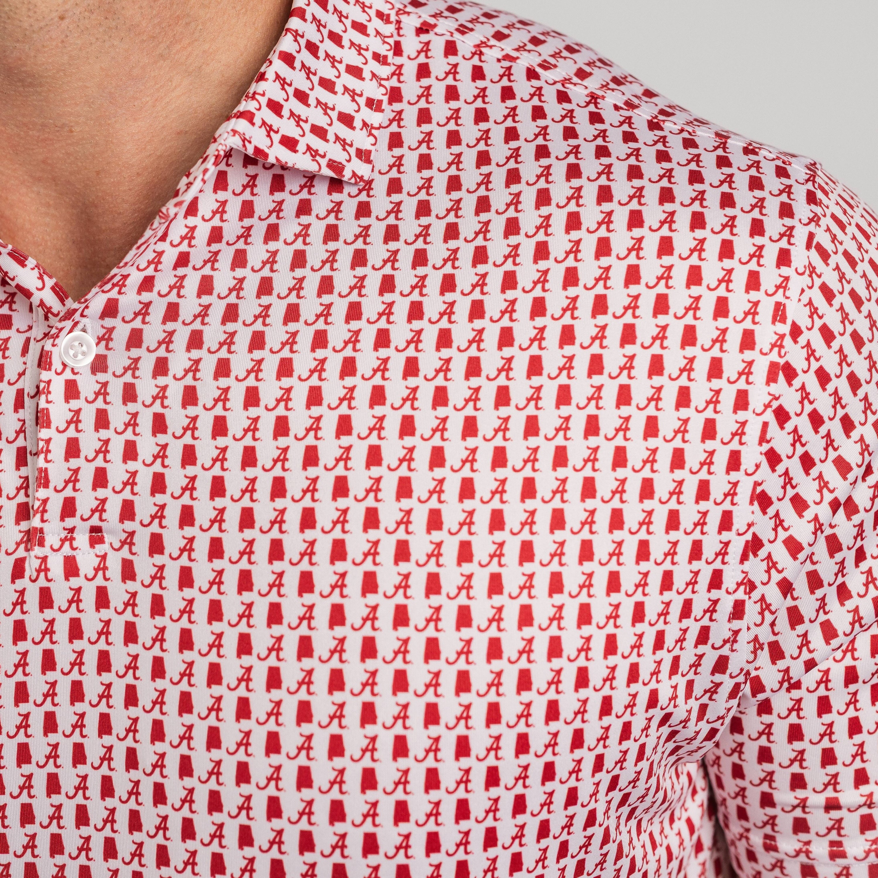 Close-up of a red and white patterned shirt with a logo on a gray background