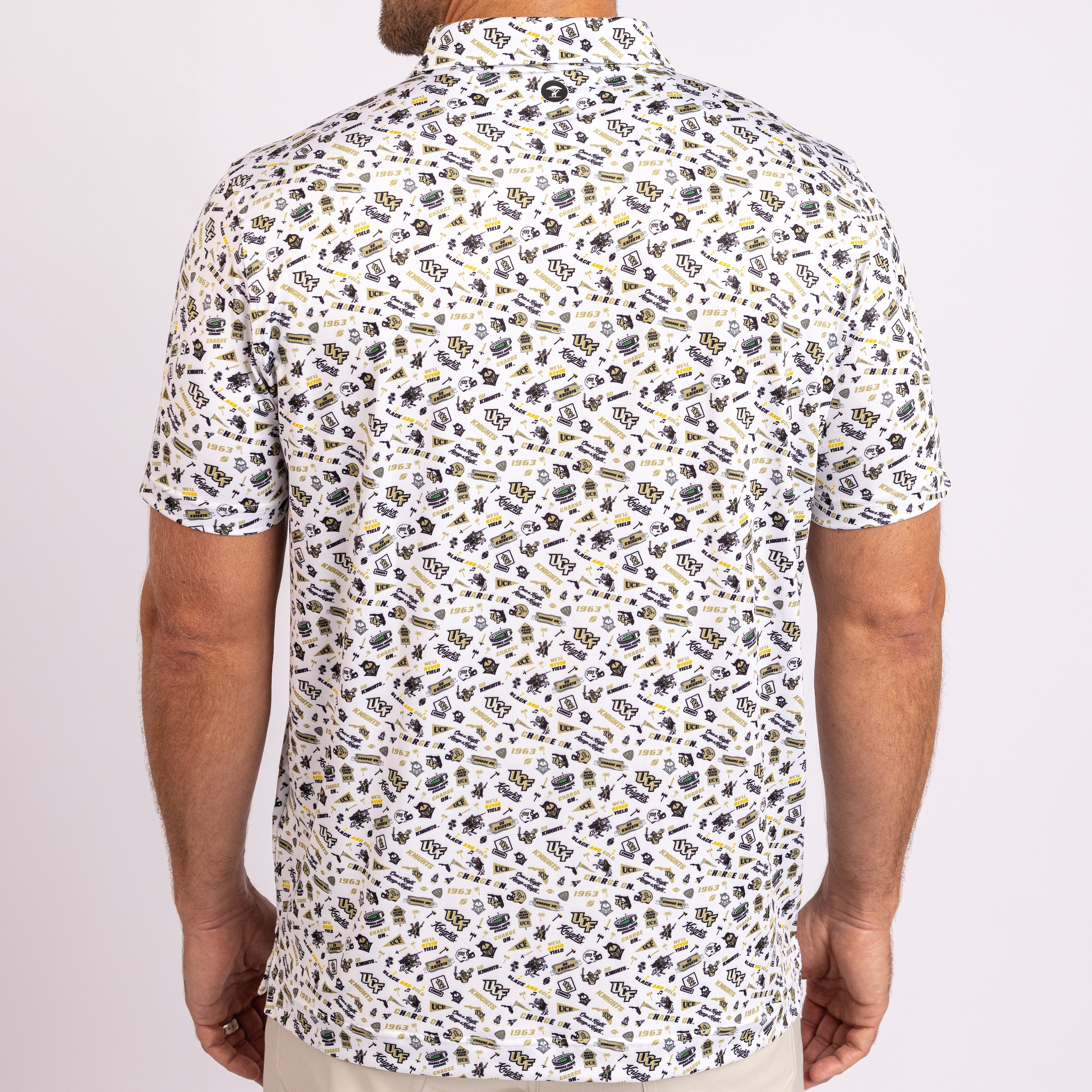 A man wearing a short-sleeve button-up shirt from the back, featuring an all-over repeating pattern