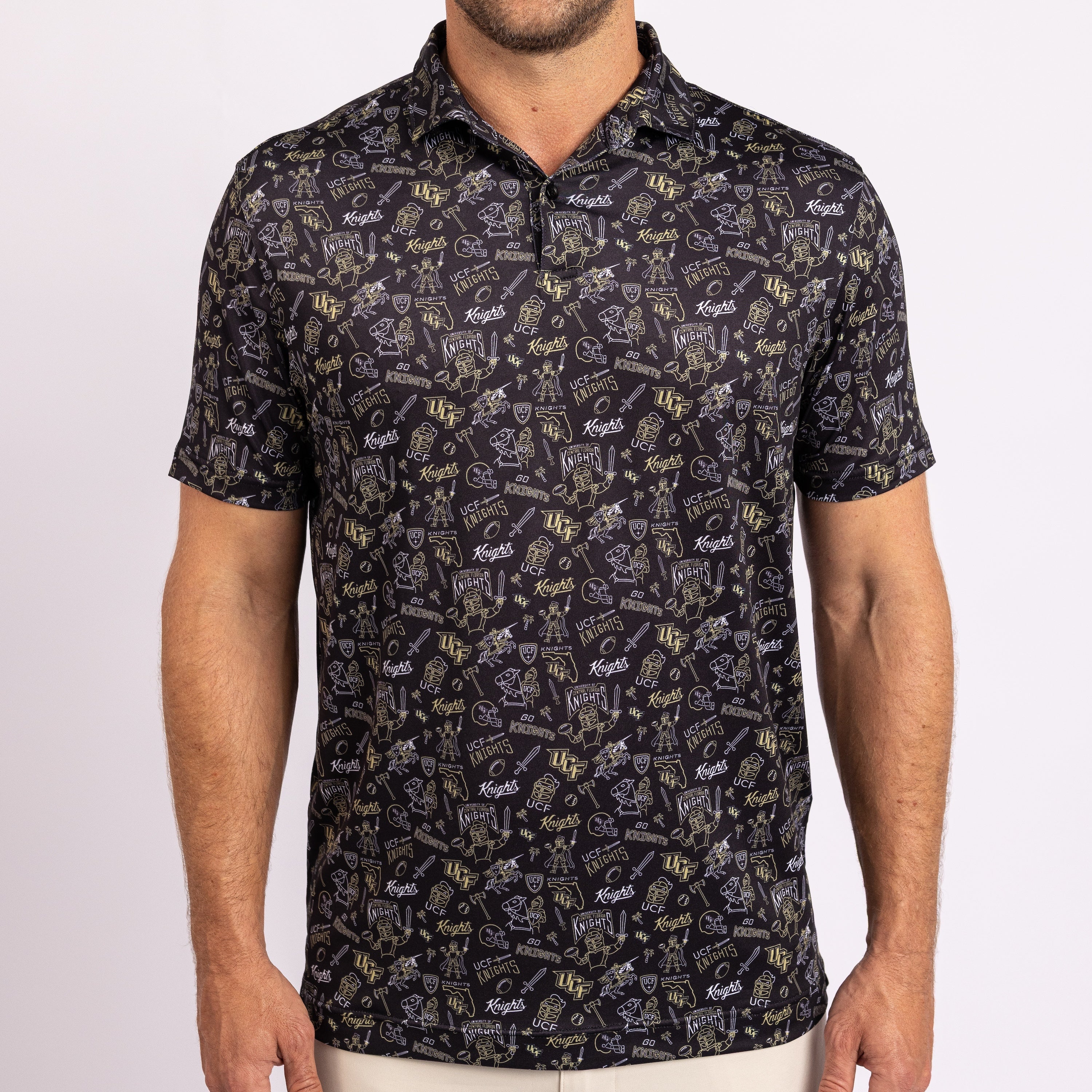 A man wearing a short-sleeve polo shirt with an all-over golf-themed print in white and gold on a black background.