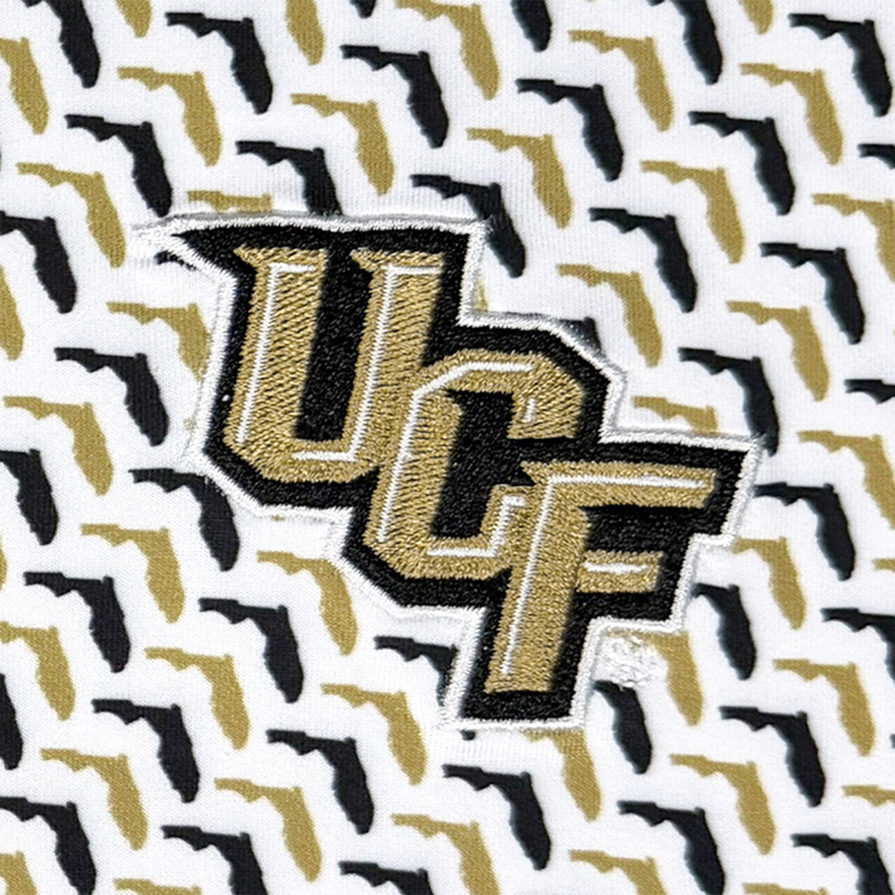 Close-up of an embroidered patch featuring the letters 'UCF' in gold and black with a white outline, set against a white background.