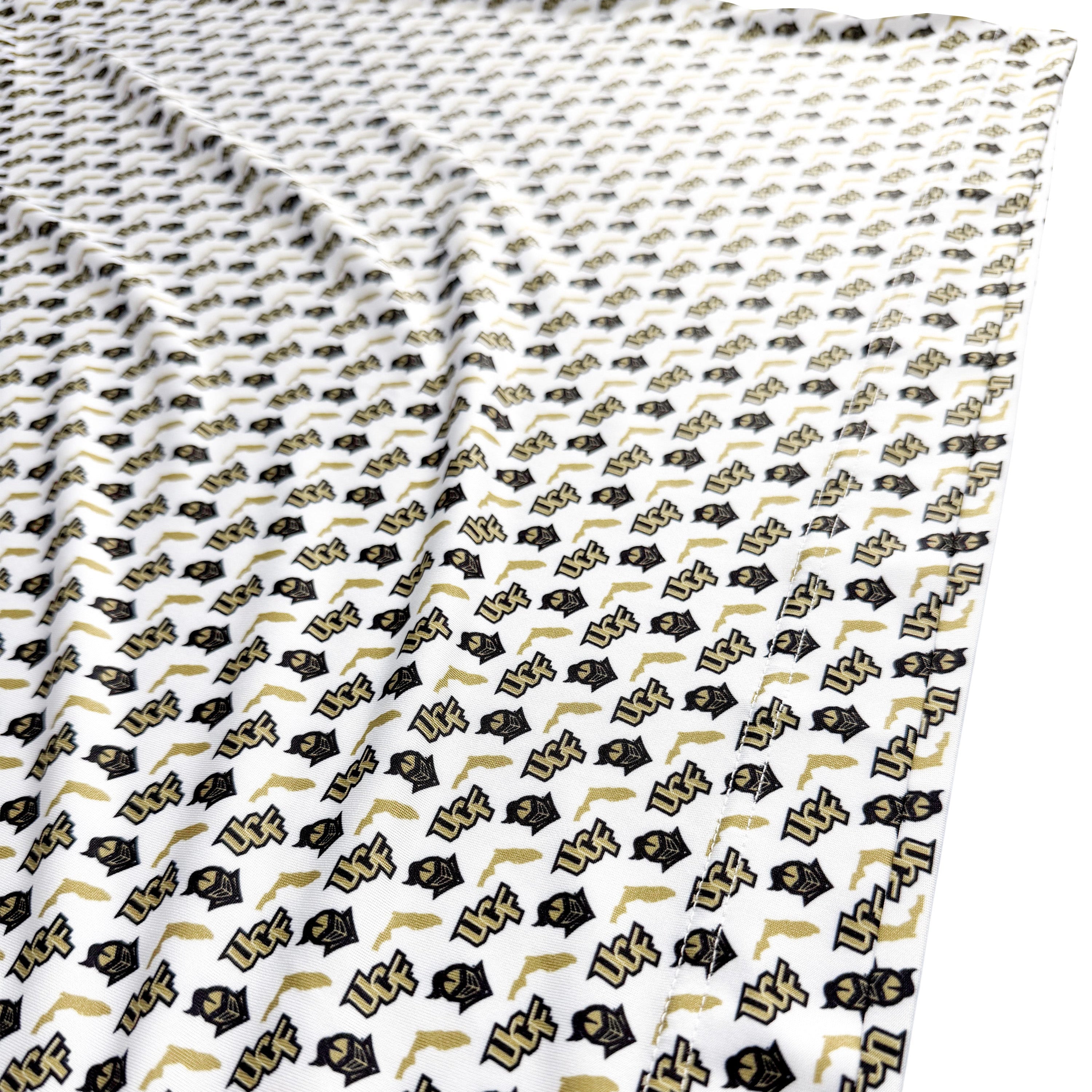 Patterned fabric with black and gold symbols on a white background