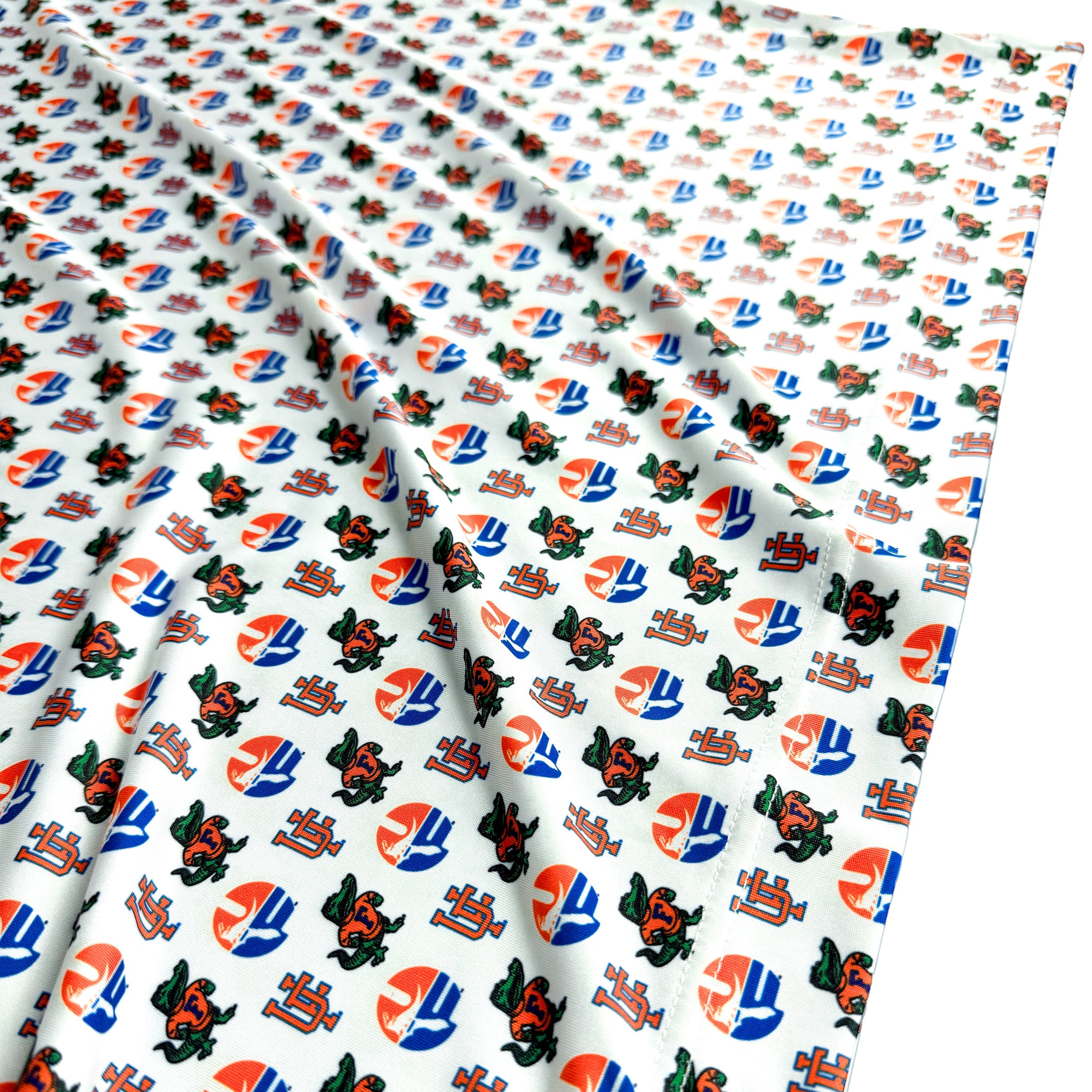 Fabric with a pattern of logos on a white background