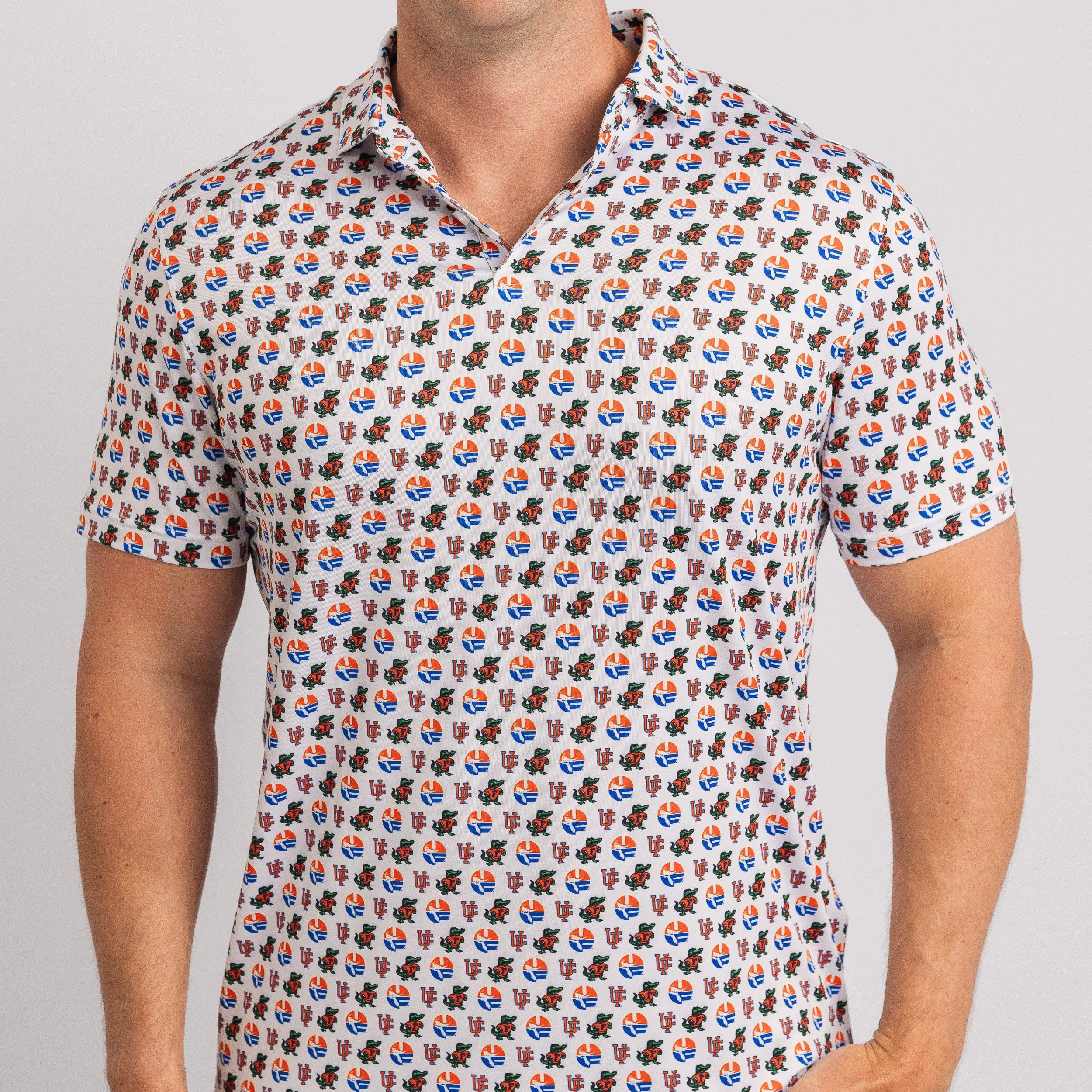 Person wearing a patterned polo shirt with small graphics on a plain background