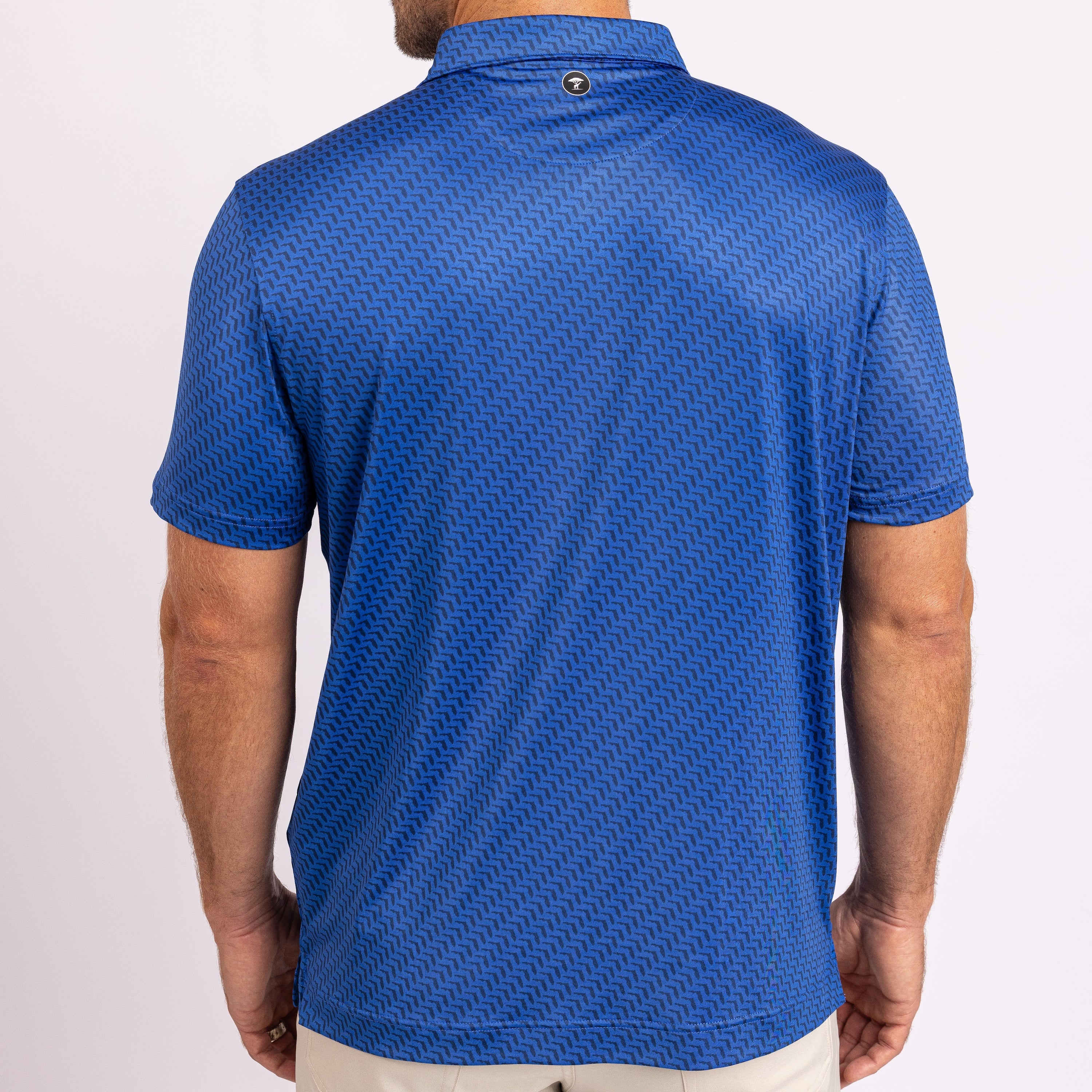 A man wearing a blue short-sleeve polo shirt with a subtle geometric pattern, shown from the back against a plain white background.