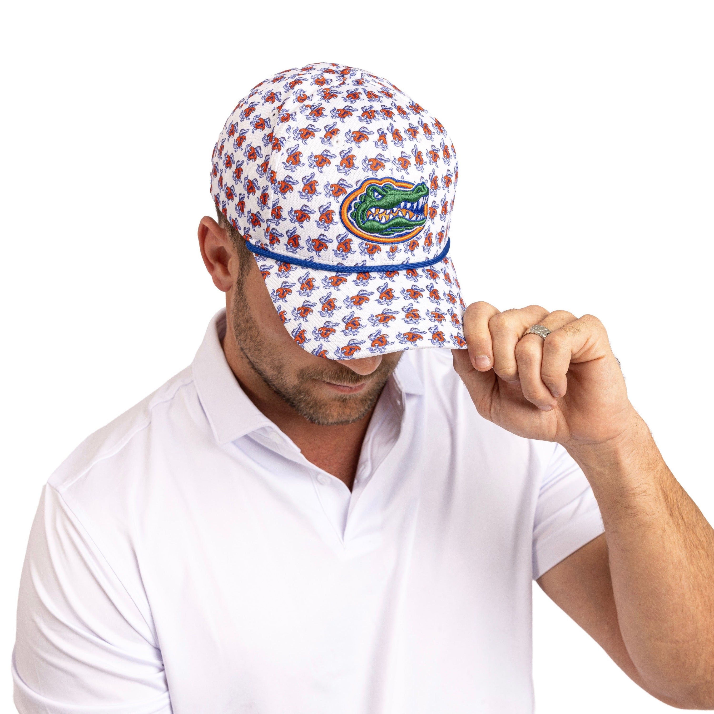 A man wearing a white baseball cap with a blue and orange alligator pattern and the Florida Gators logo on the front, paired with a white polo shirt against a white background.