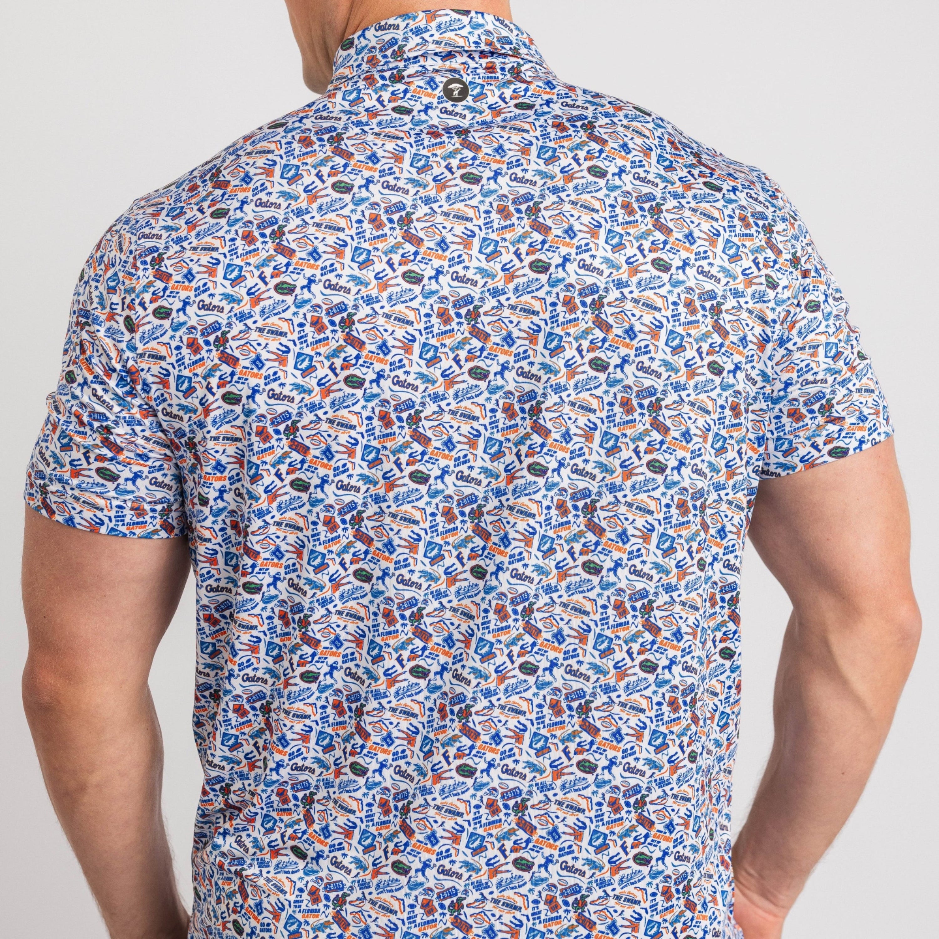 Man wearing a short-sleeve shirt with a colorful pattern on a plain background