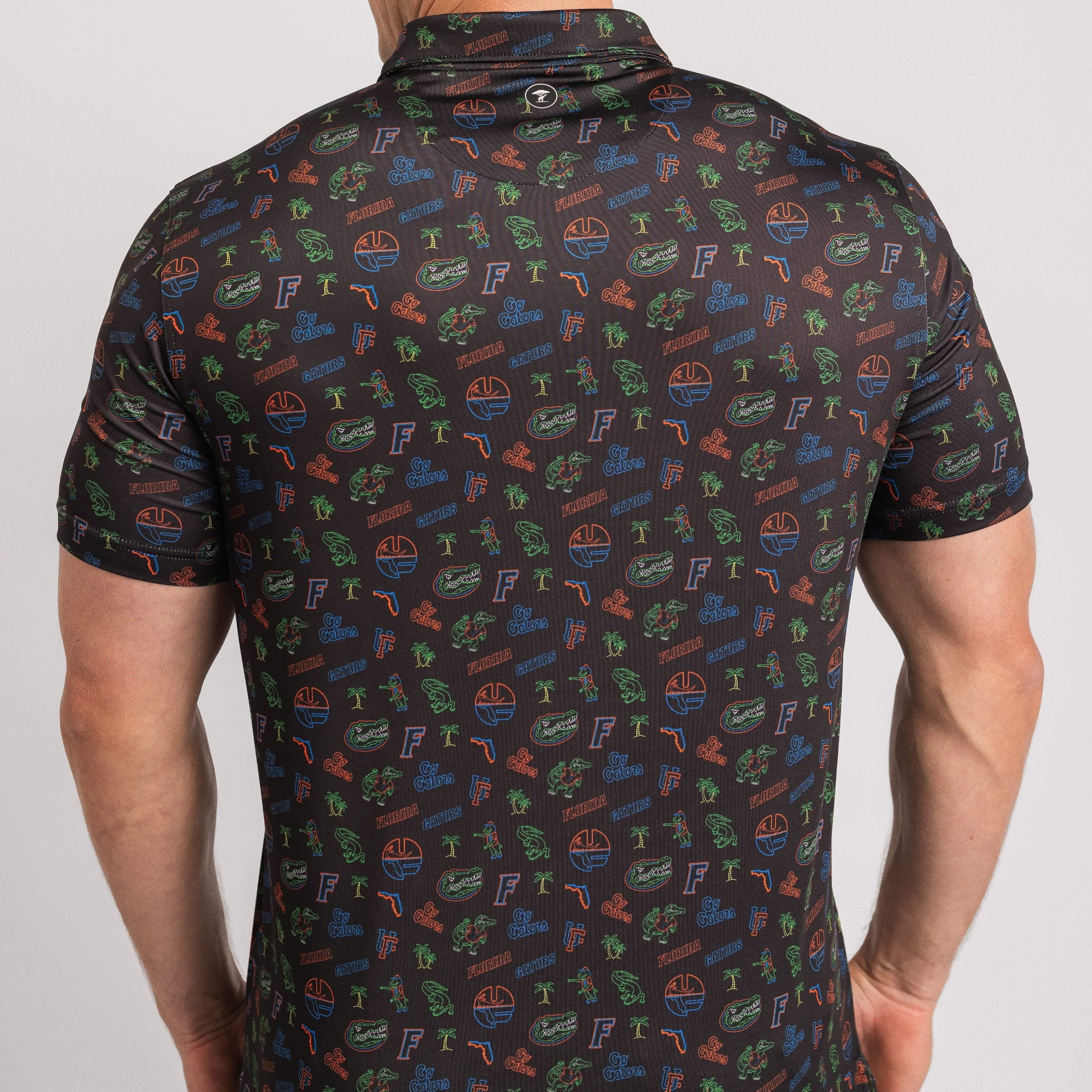 Man wearing a dark polo shirt with colorful pattern on a white background