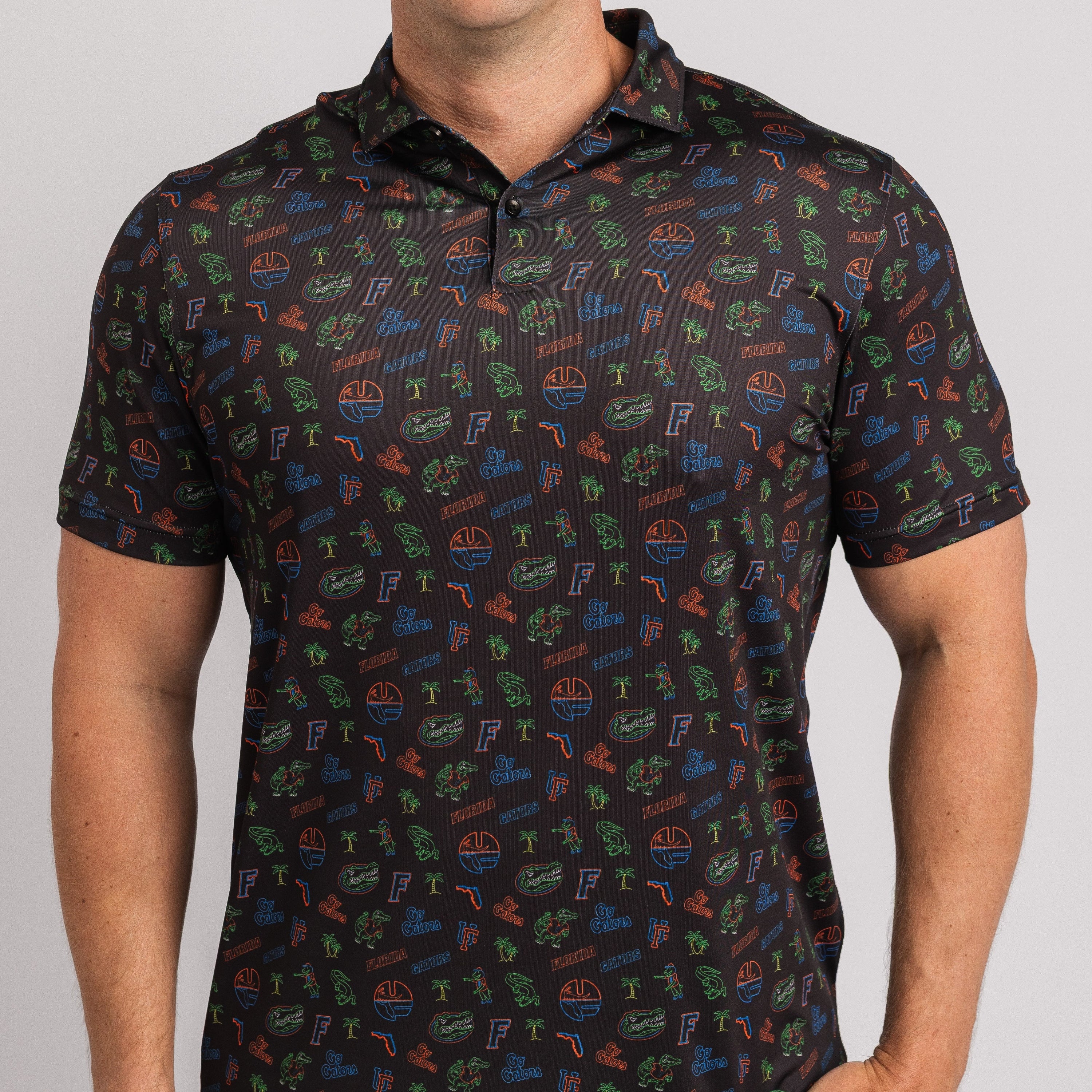 Man wearing a patterned black polo shirt on a white background