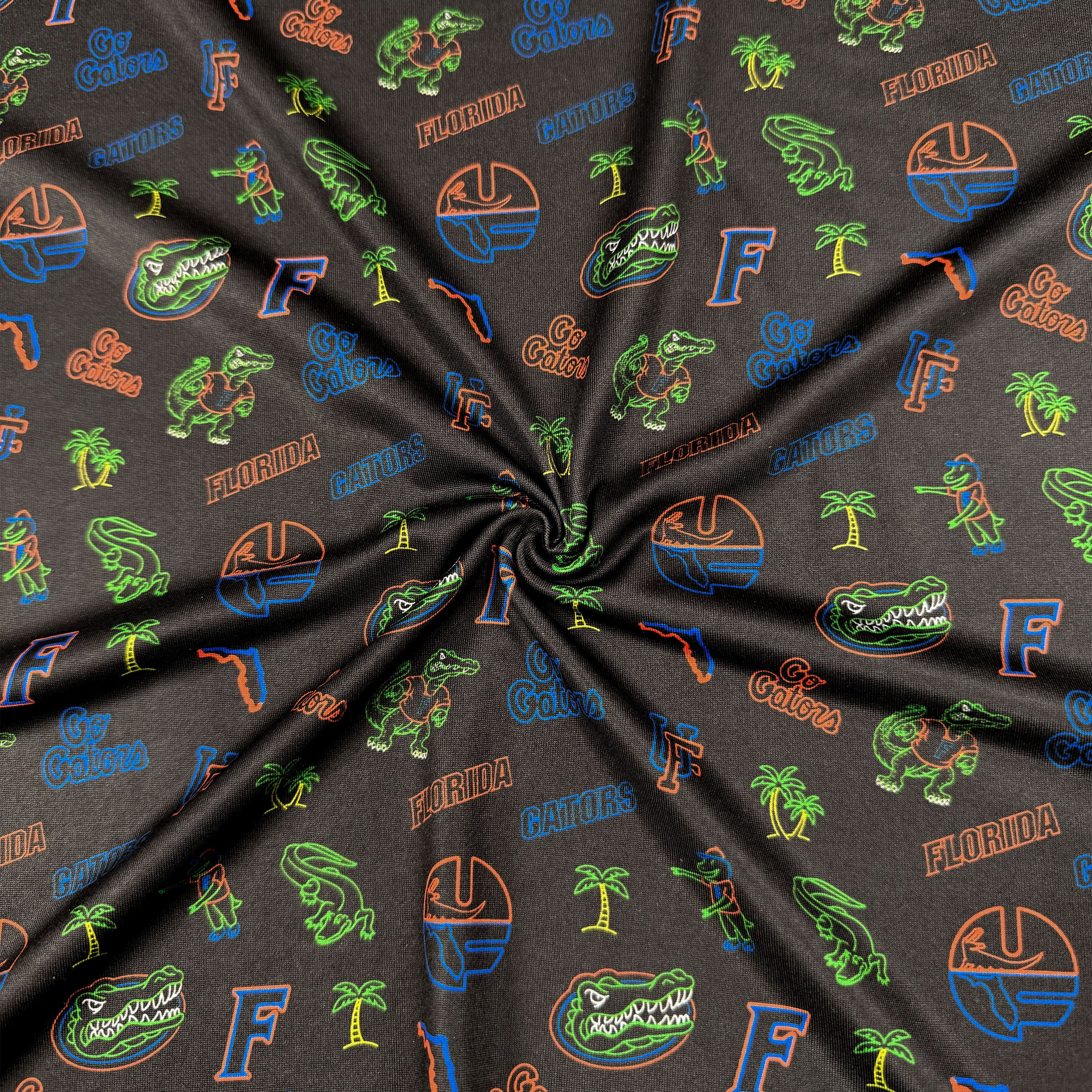 Fabric with Florida Gators logos and designs on a dark background