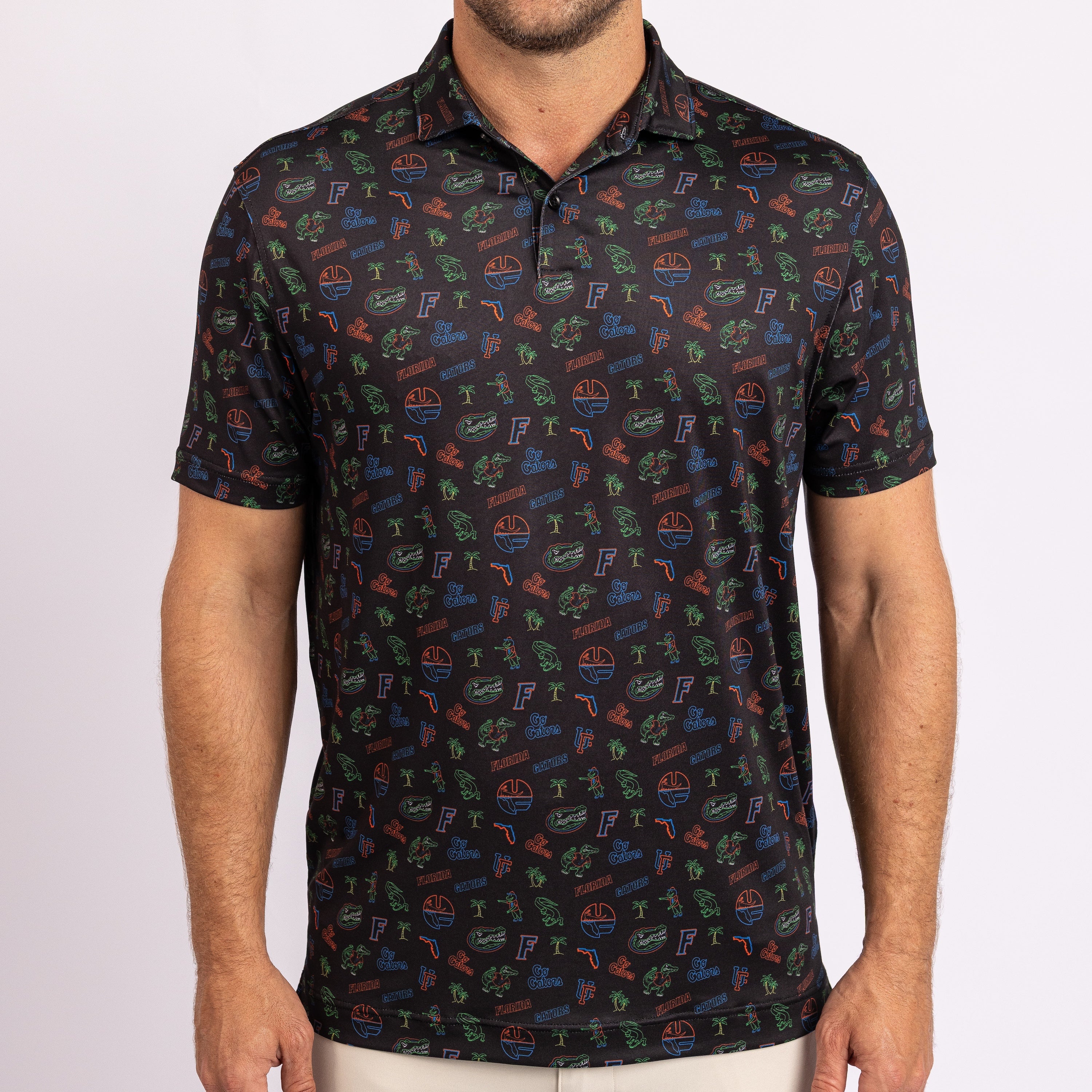 A man wearing a short-sleeve polo shirt with an all-over colorful graphic print.