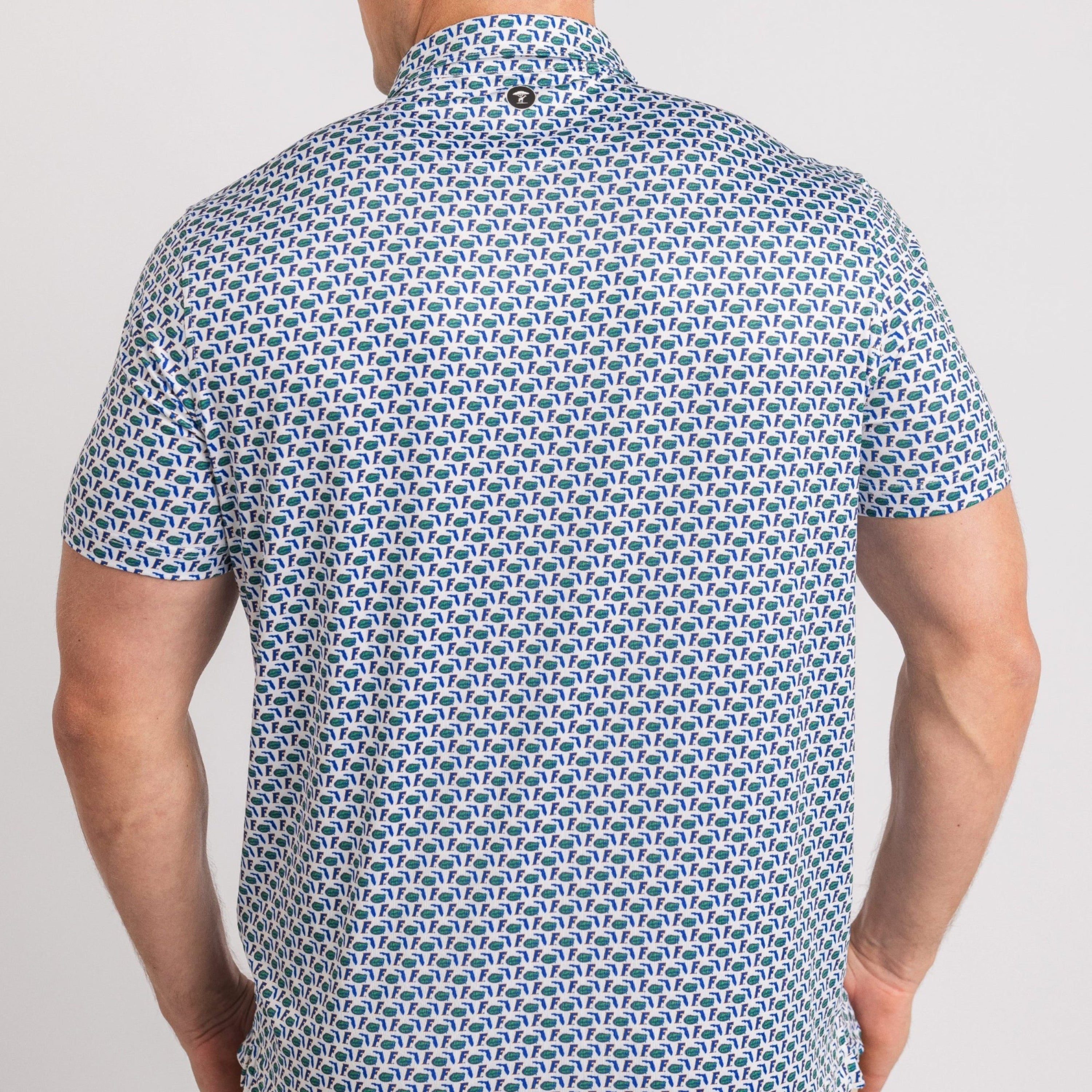Man wearing a blue patterned shirt on a plain background