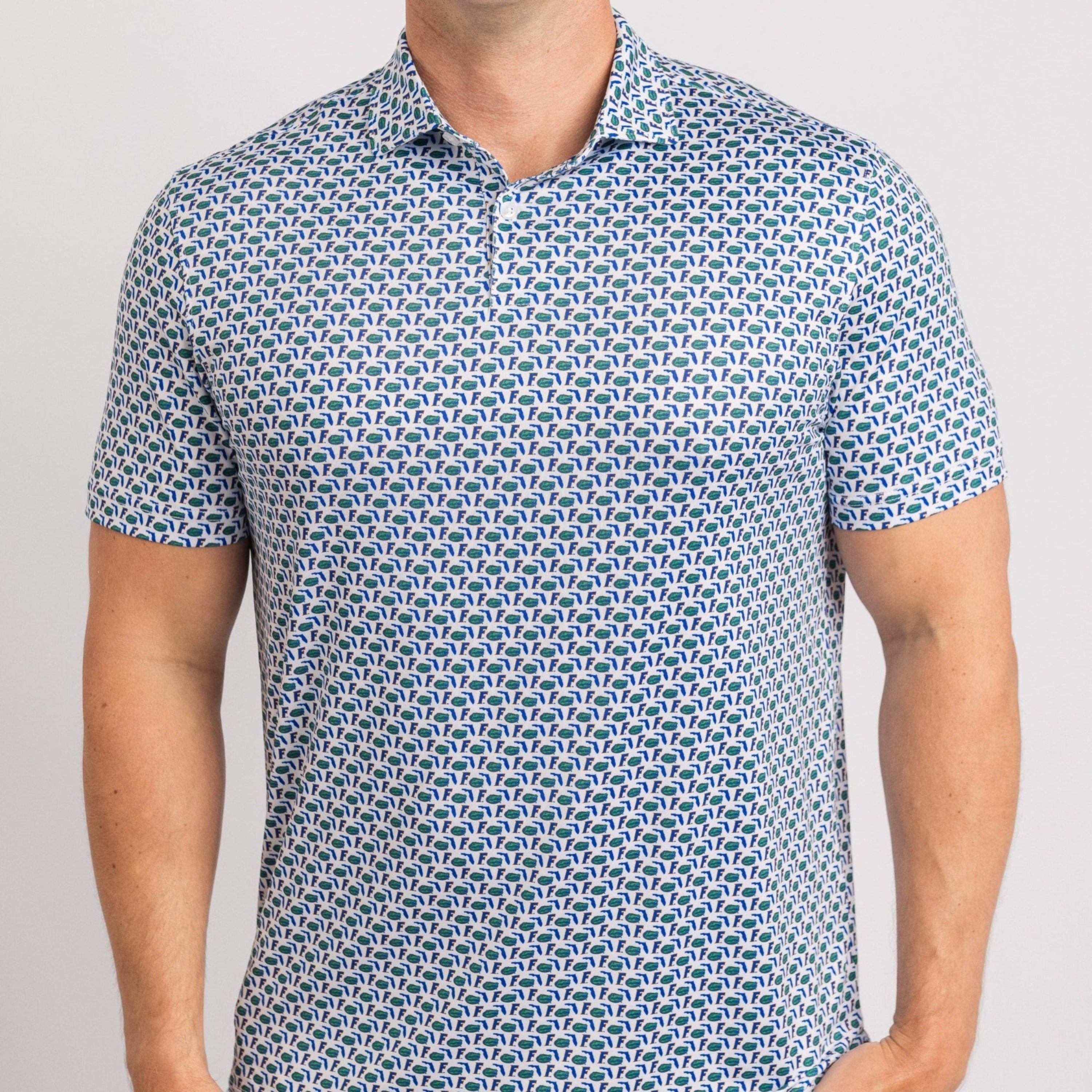 Man wearing a patterned blue and white polo shirt on a gray background