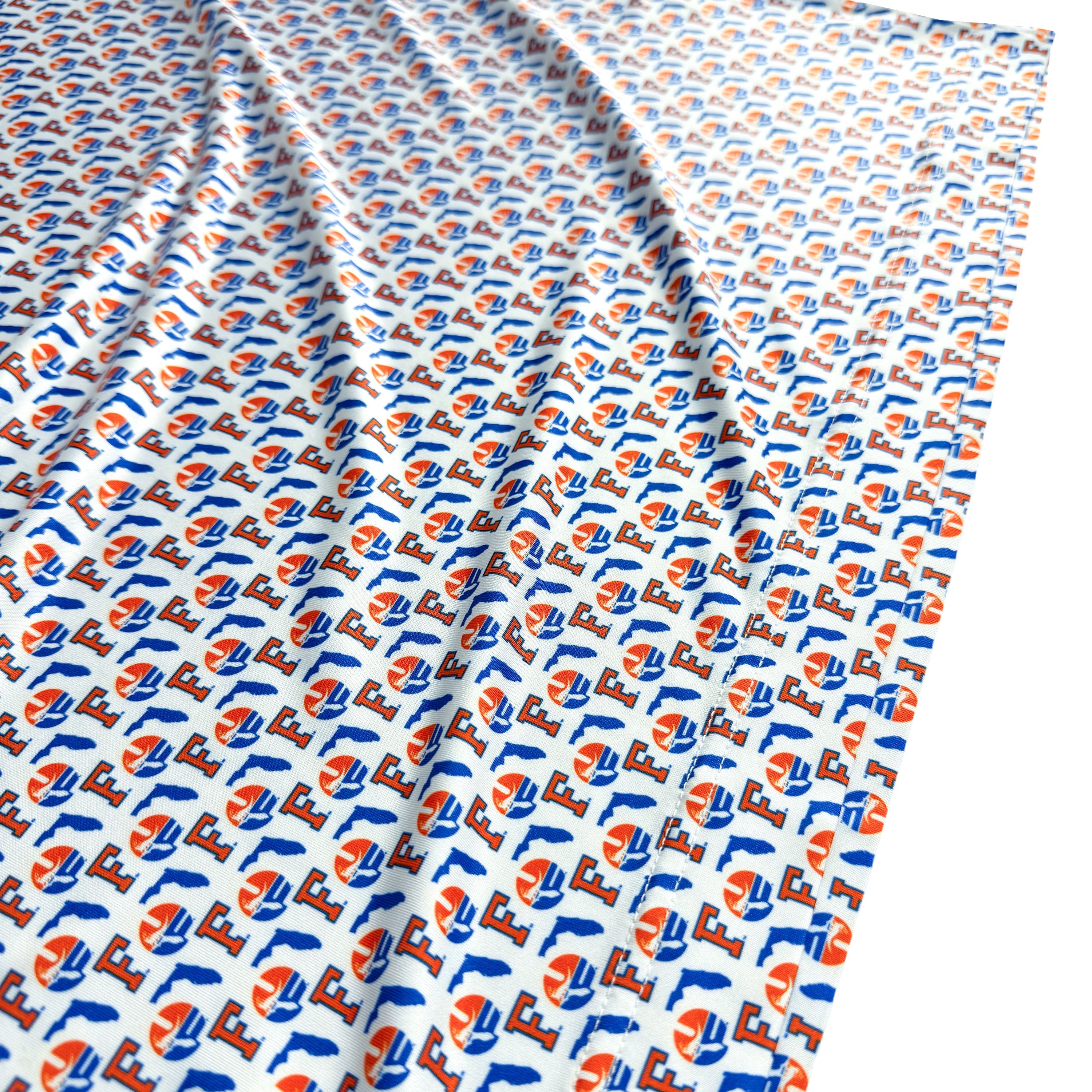 Fabric with a pattern of blue, orange, and white shapes on a white background