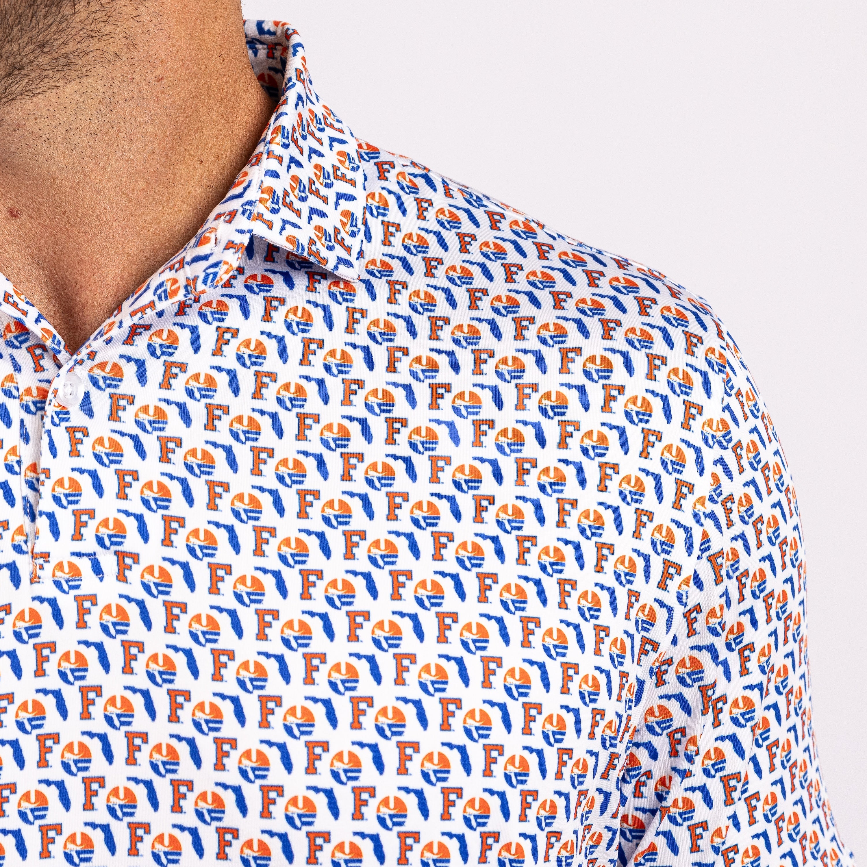 Close-up of a man wearing a white collared button-up shirt with an all-over repeating orange and blue Florida Gators logo pattern.