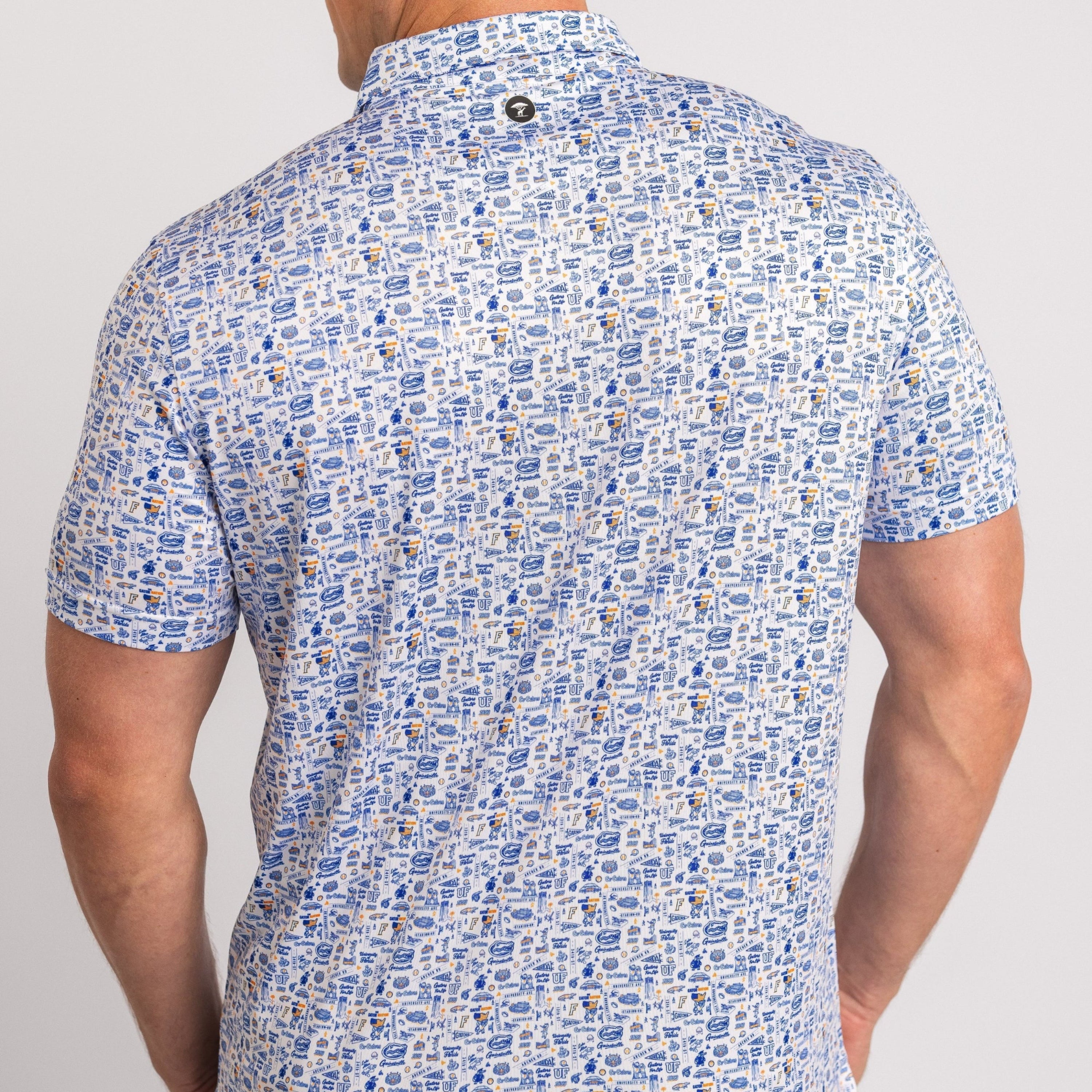 Man wearing a patterned short-sleeve shirt on a plain background