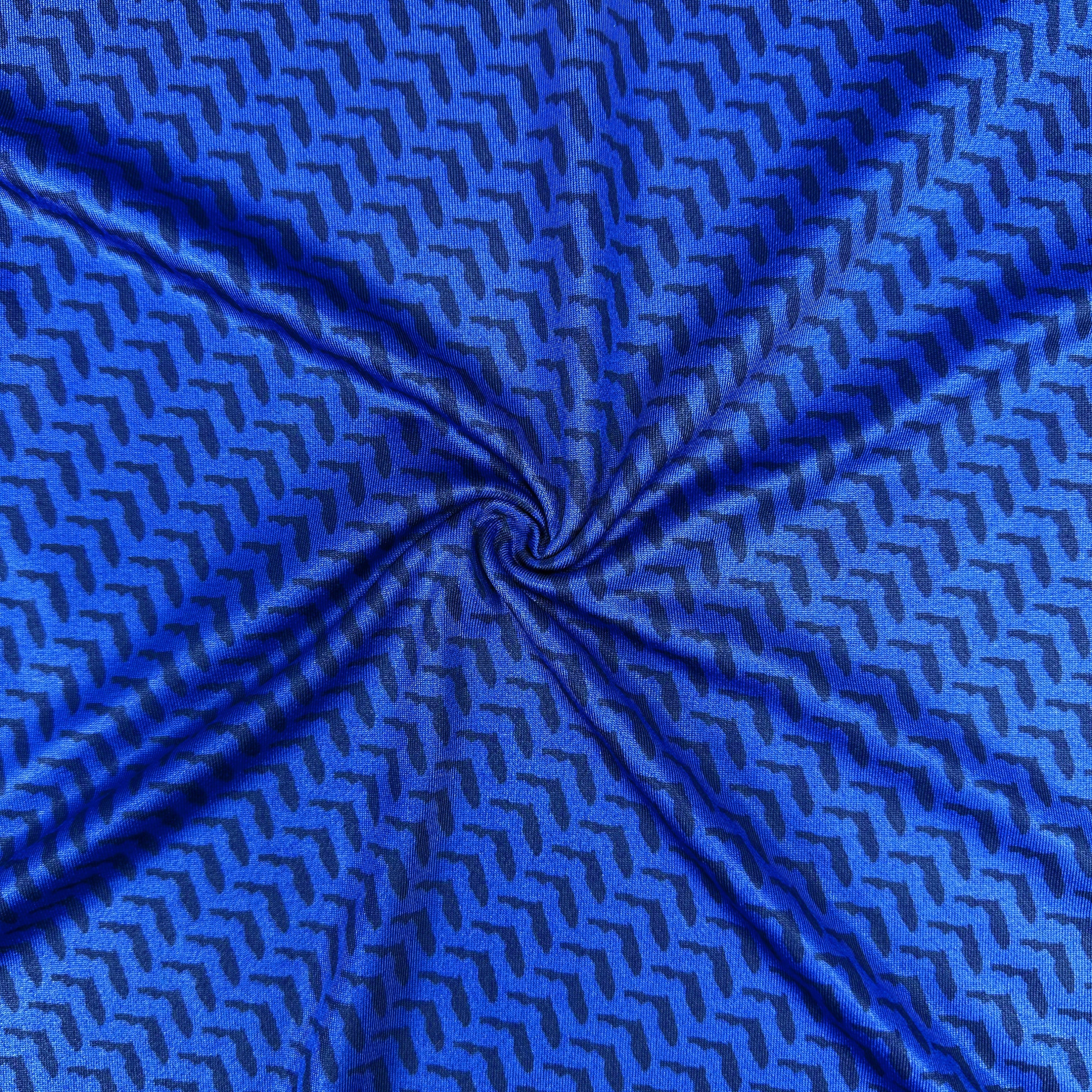 Blue fabric with a geometric pattern, possibly silk or satin.