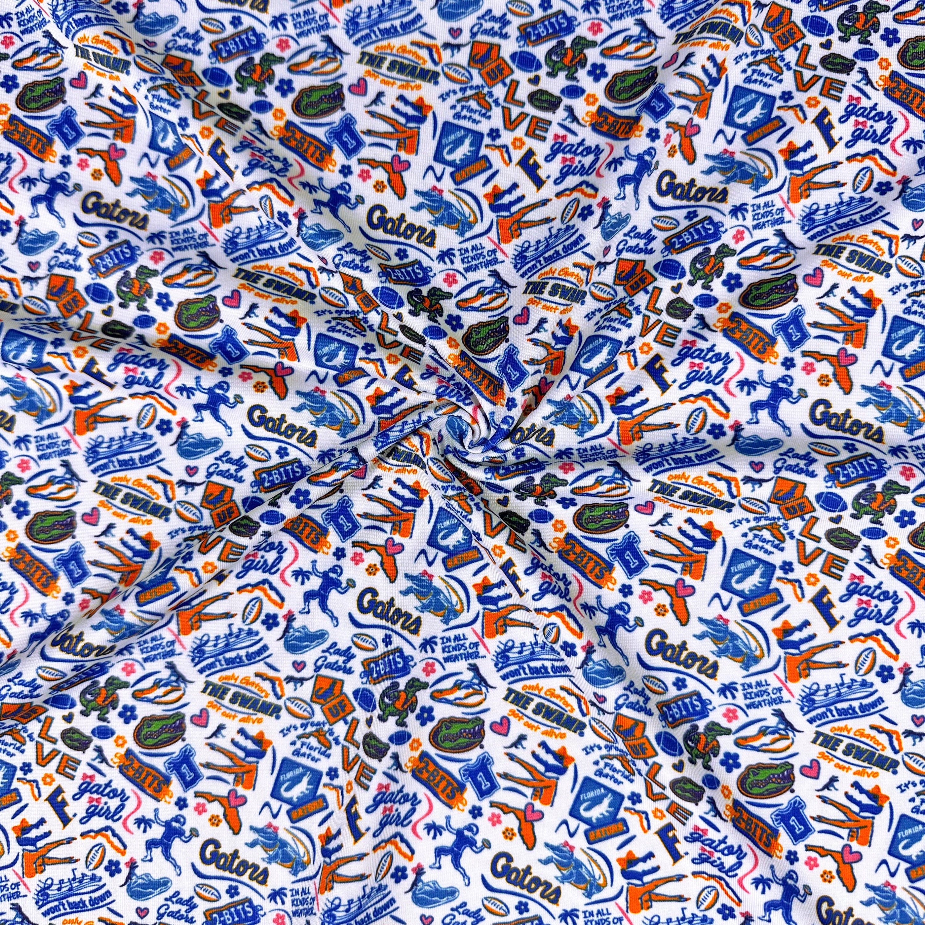 Fabric with colorful 'Gators' pattern featuring footballs, cars, and other graphics.