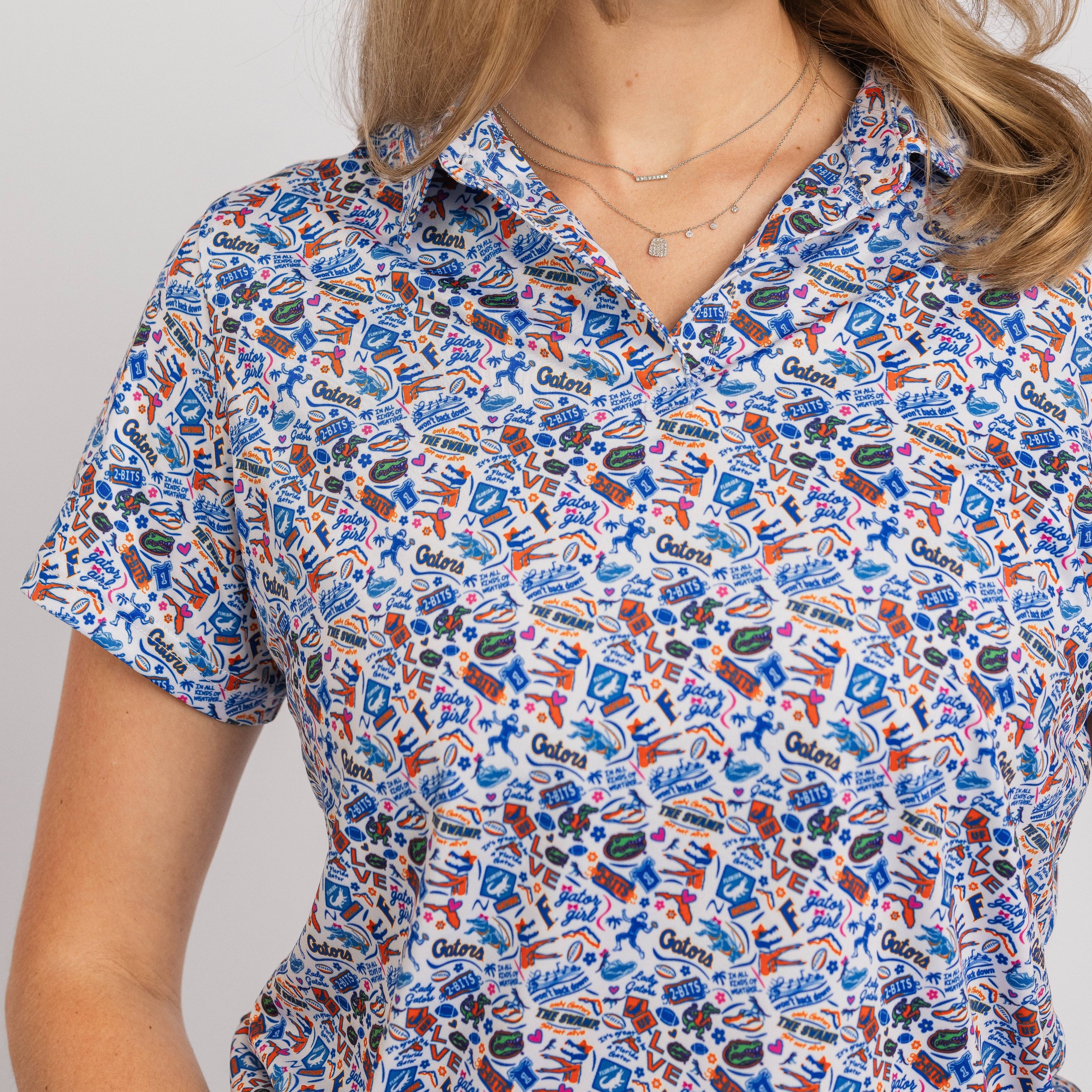 Person wearing a colorful patterned shirt with visible branding on a plain background