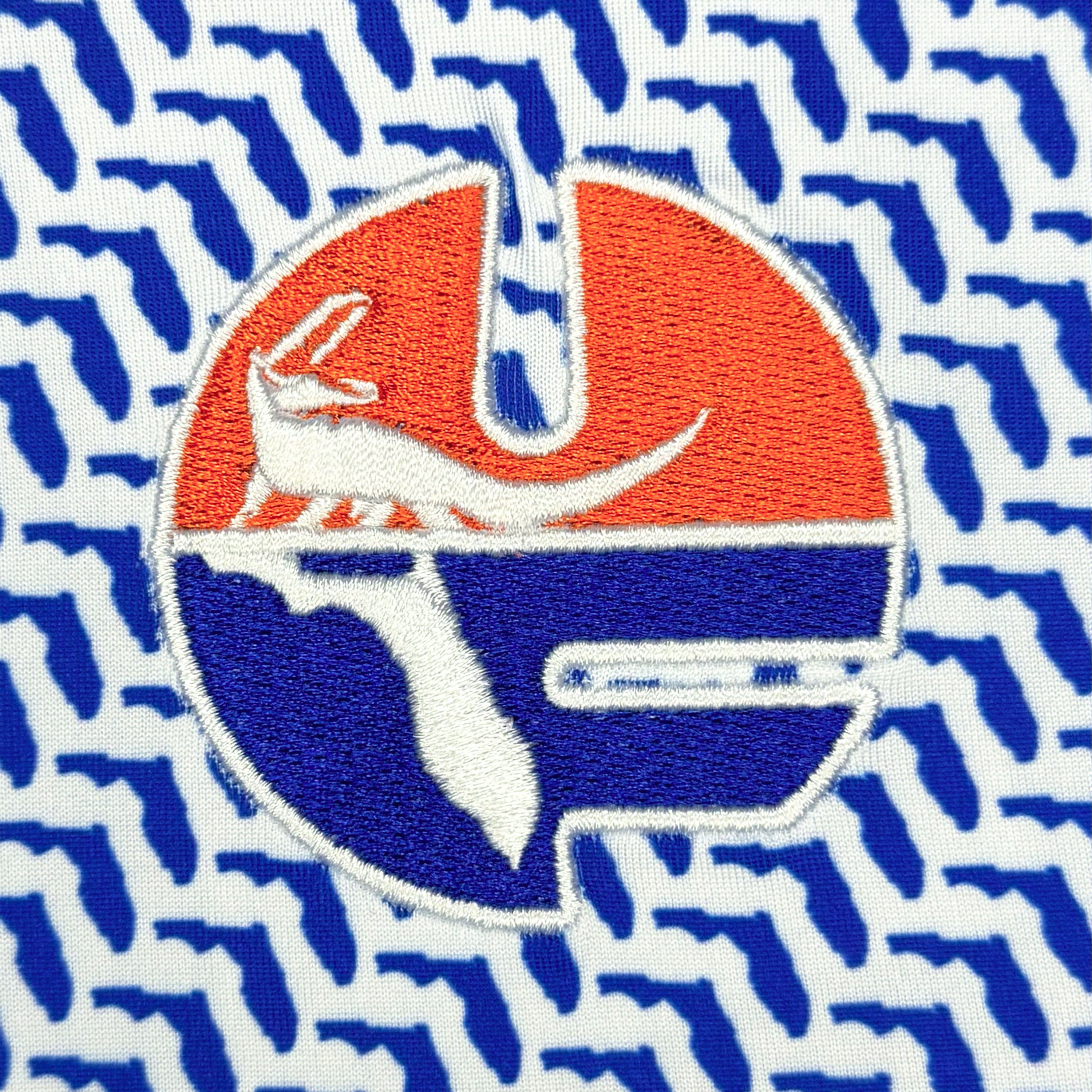 Logo with a red and blue design on a blue patterned background