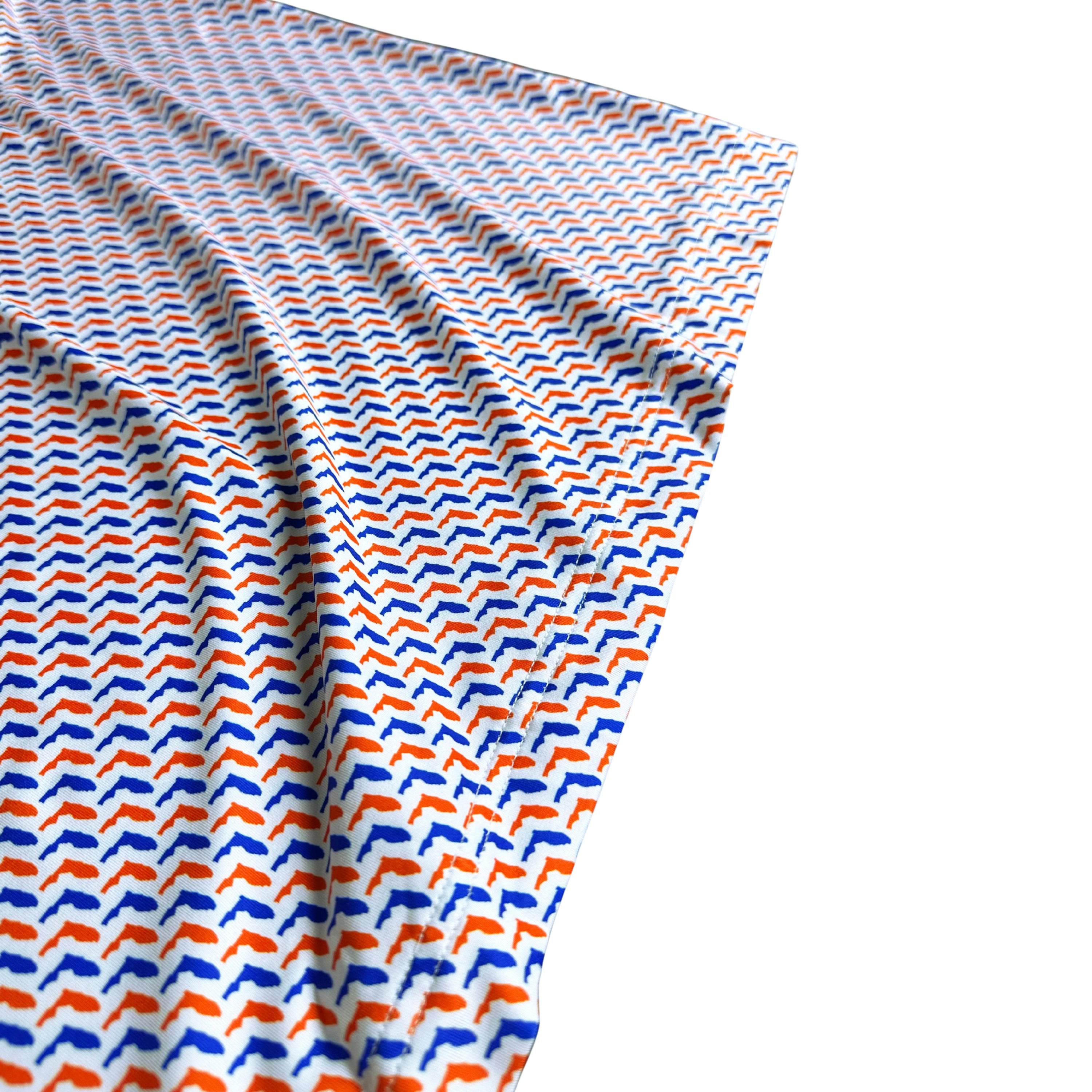 Folded fabric with blue and orange pattern on a white background