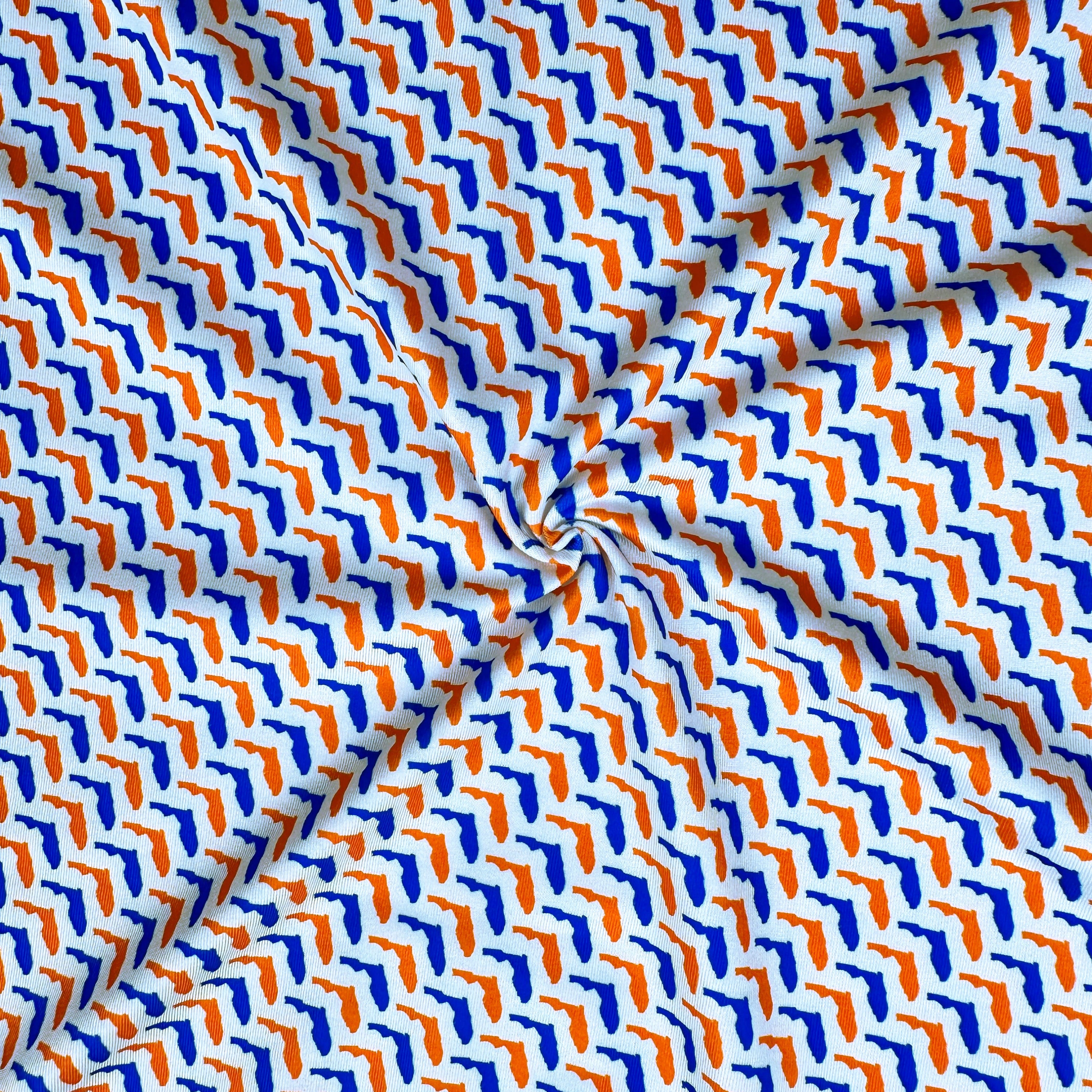 Patterned fabric with blue and orange shapes on a white background