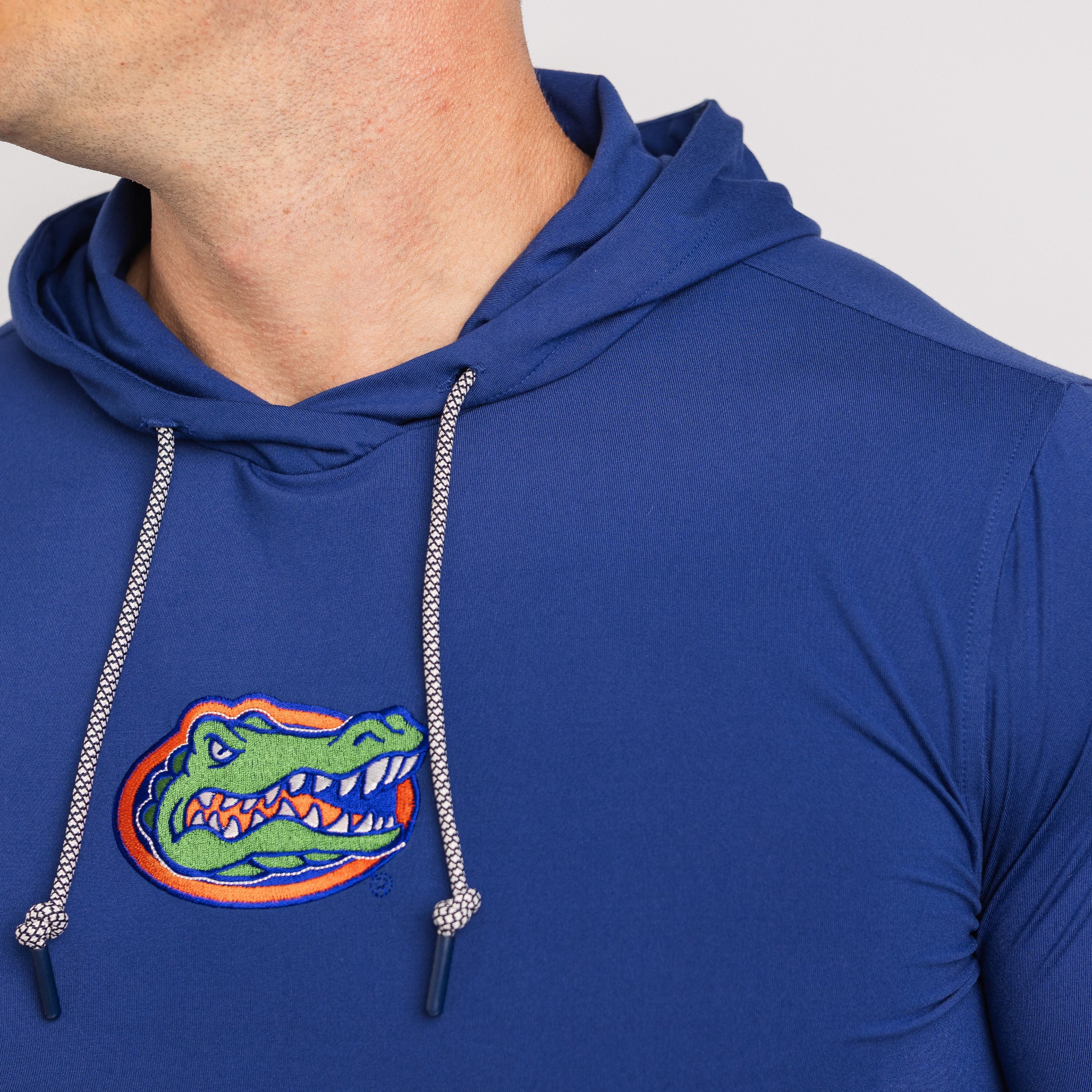 Blue hoodie with a gator logo on a gray background