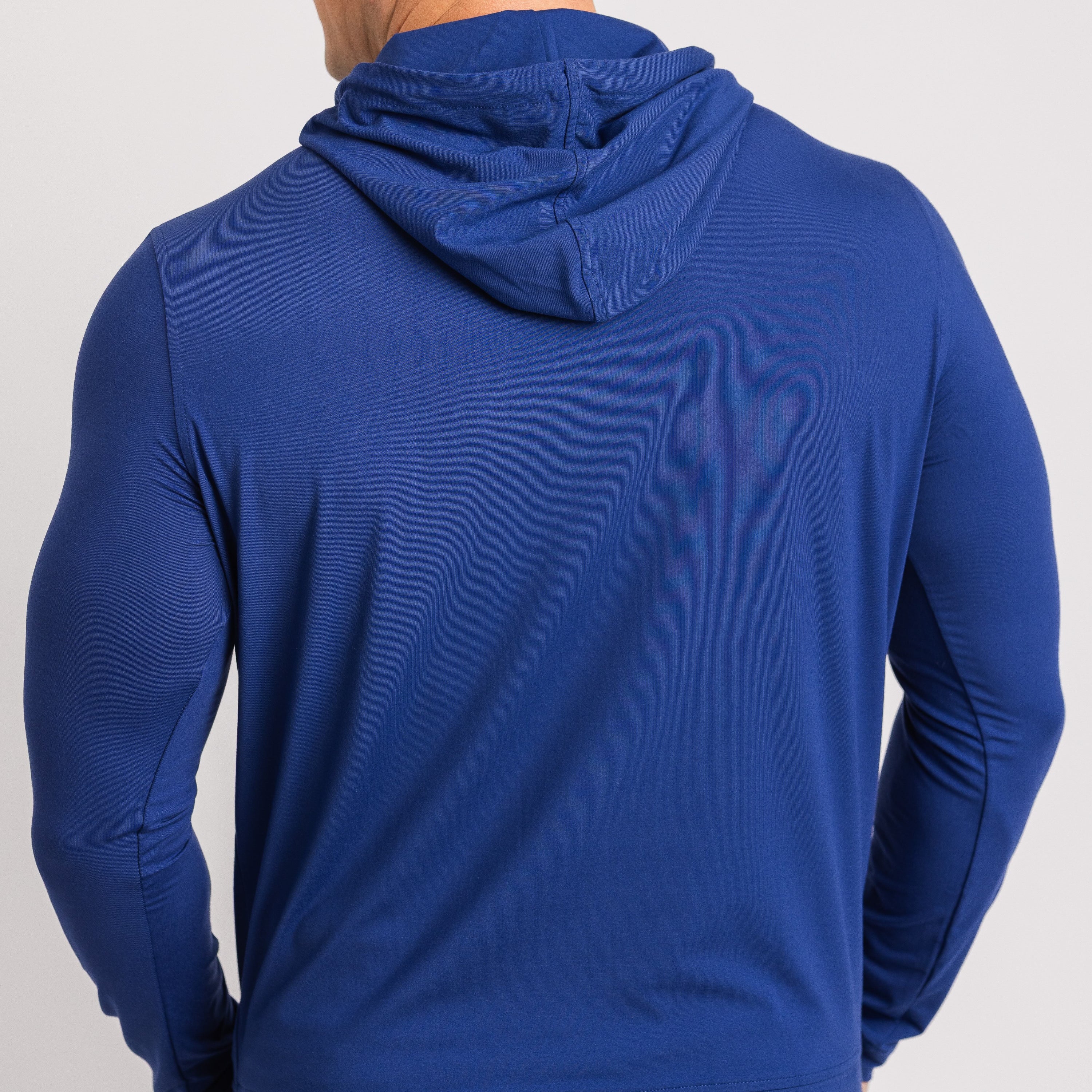 Blue hoodie worn by a person on a light gray background