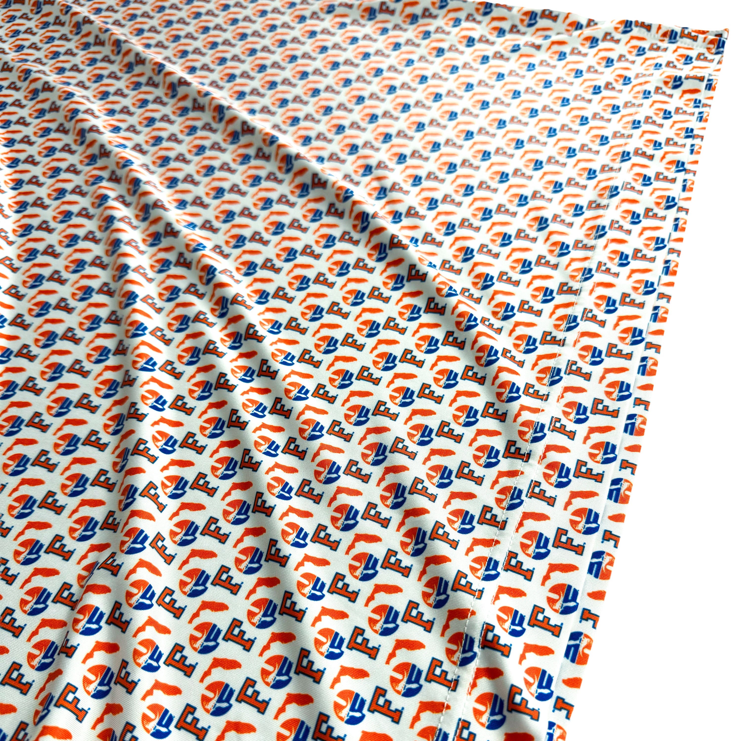 Patterned fabric with orange, blue, and white design on a white background