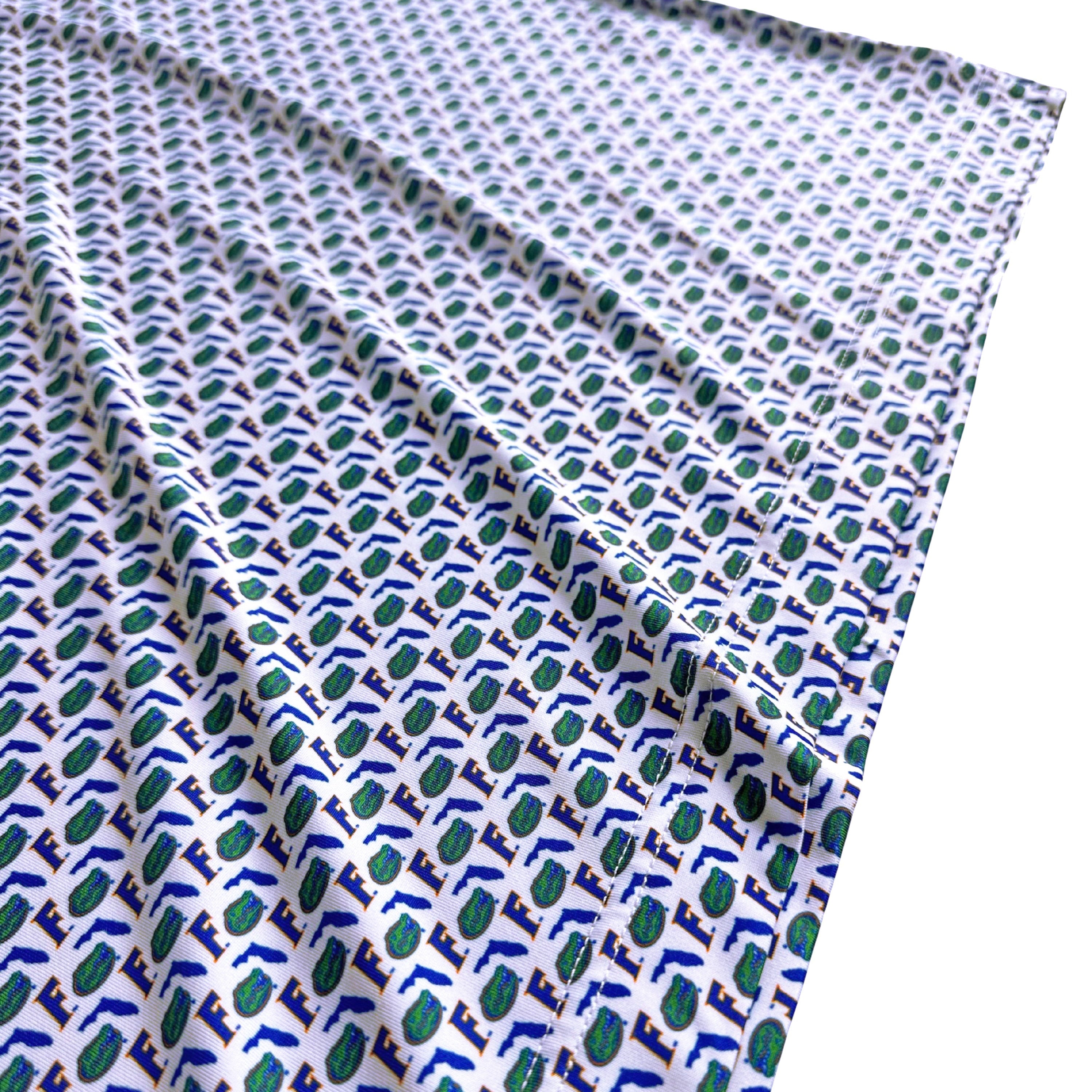 Fabric with blue and green geometric pattern on a white background