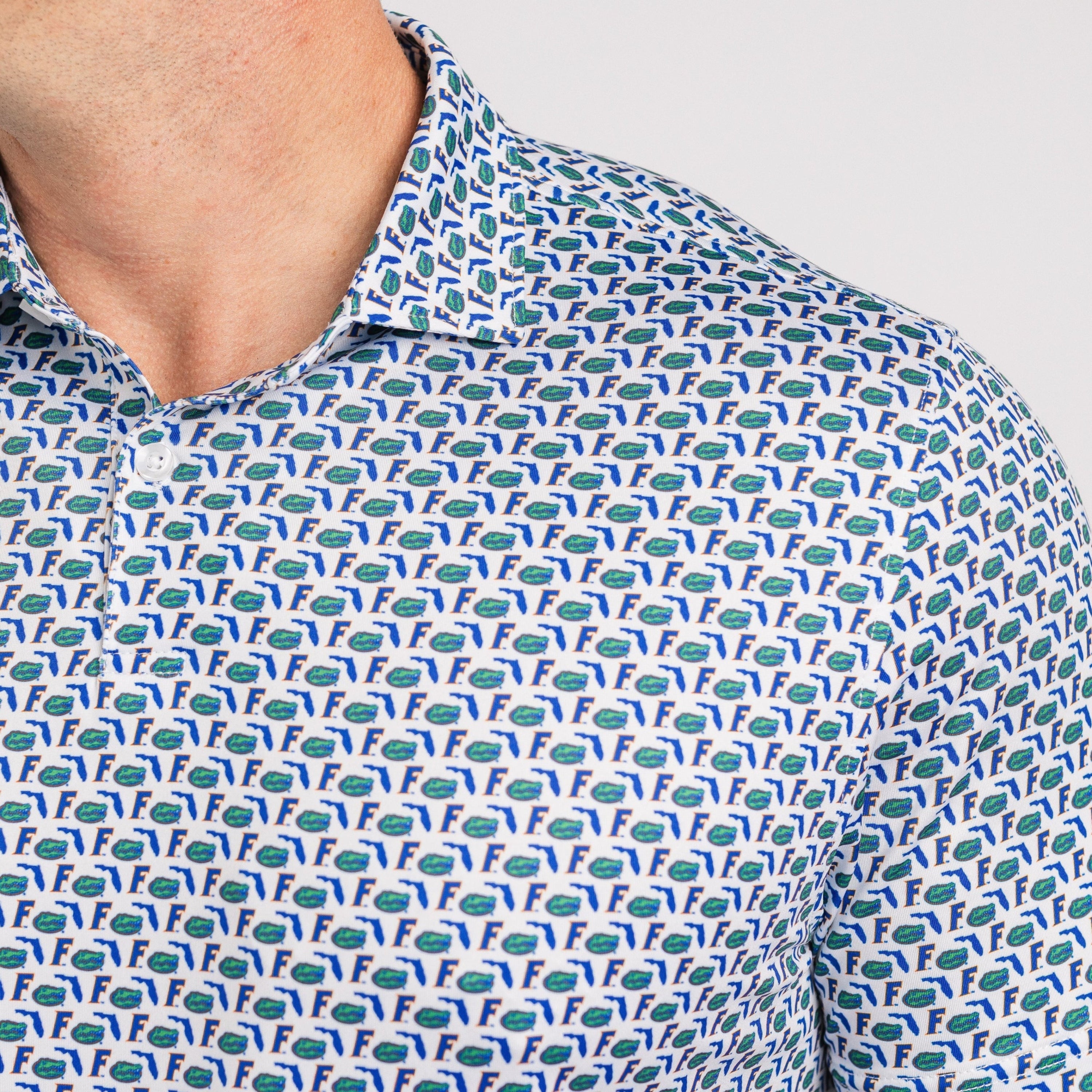 Close-up of a patterned shirt with small animal figures on a plain background