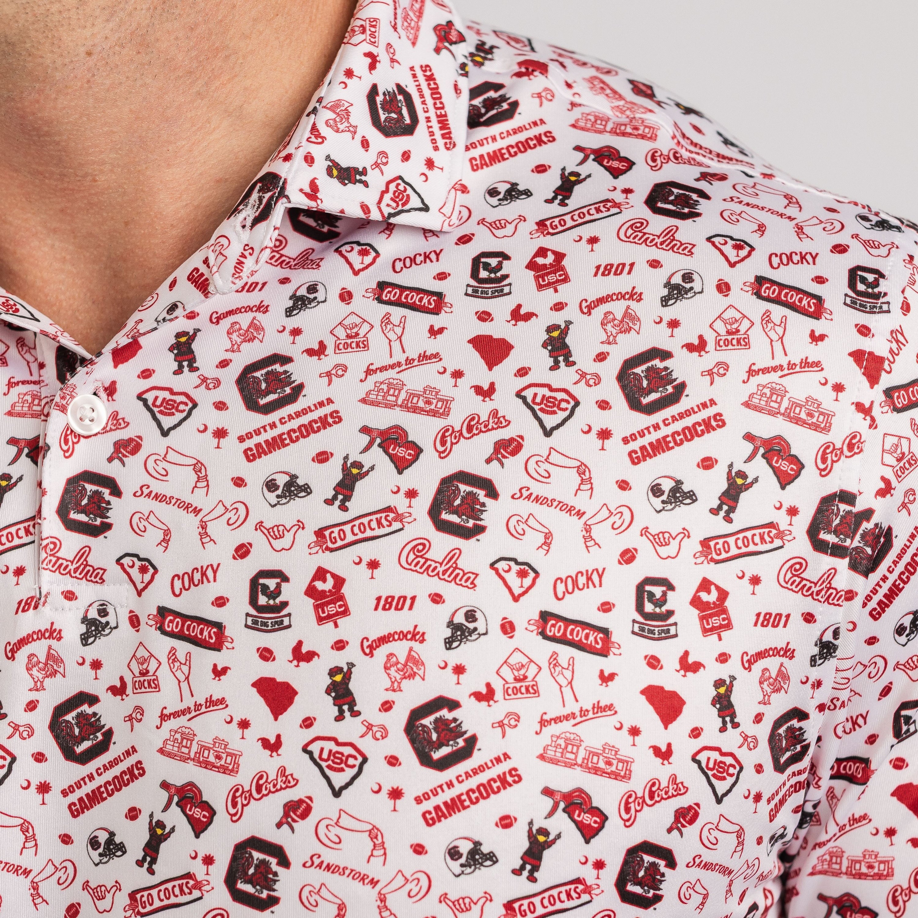 Close-up of a shirt with a red and black pattern featuring logos and text.