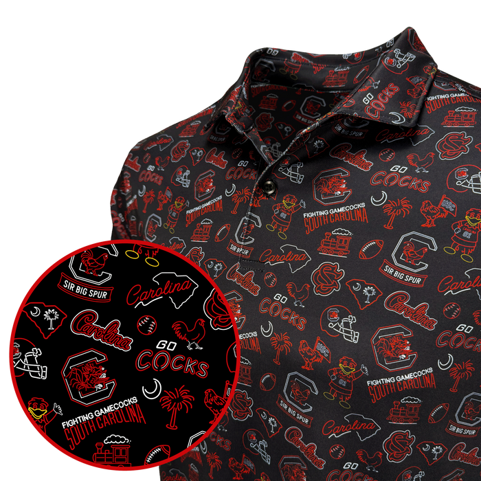 A close-up of a black polo shirt with an all-over red and white South Carolina Cocks themed graphic print, featuring a circular inset detail of the pattern.