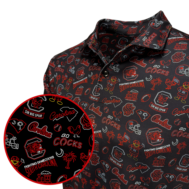 A close-up of a black polo shirt with an all-over red and white South Carolina Cocks themed graphic print, featuring a circular inset detail of the pattern.
