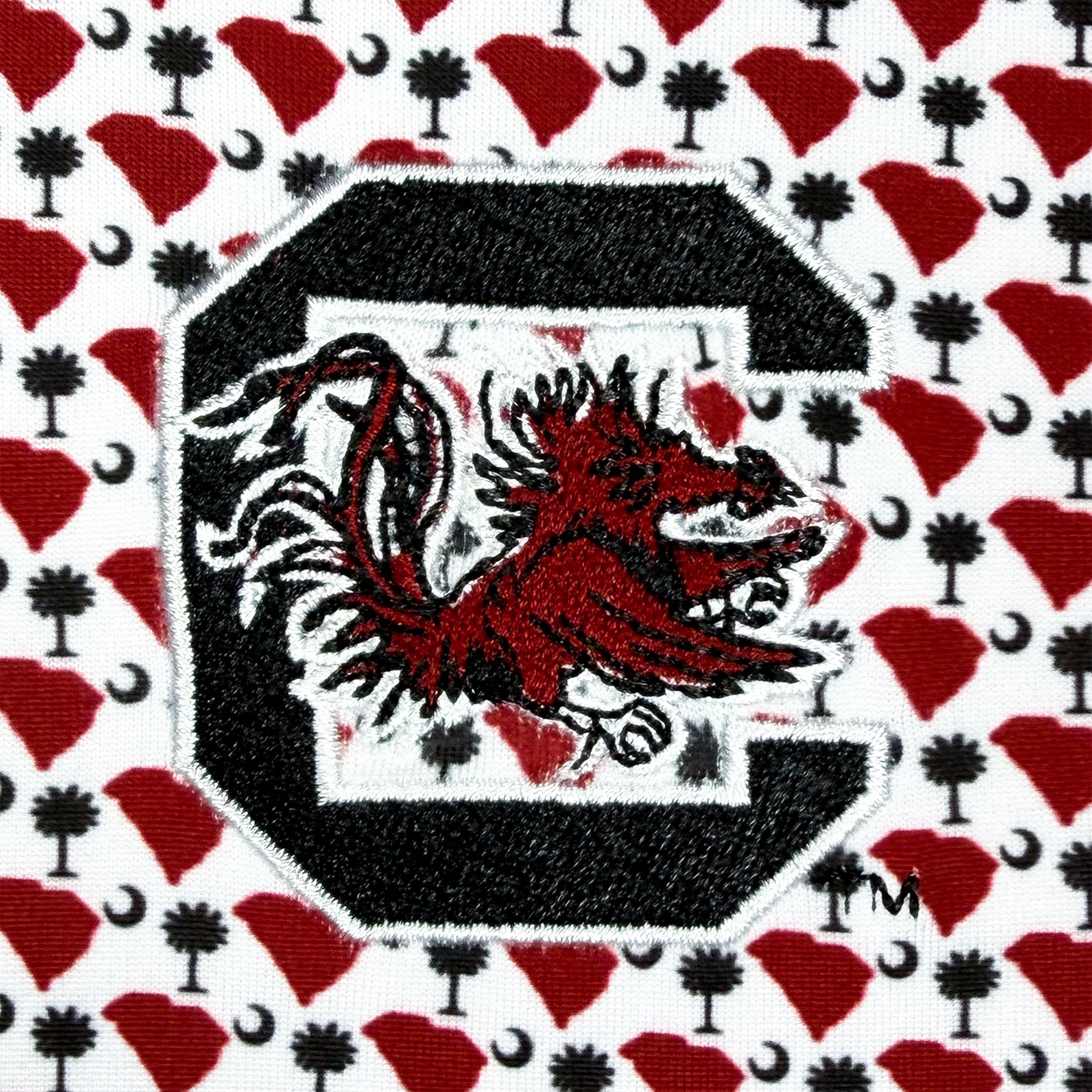 Embroidered patch of a red and black panther logo on a patterned background