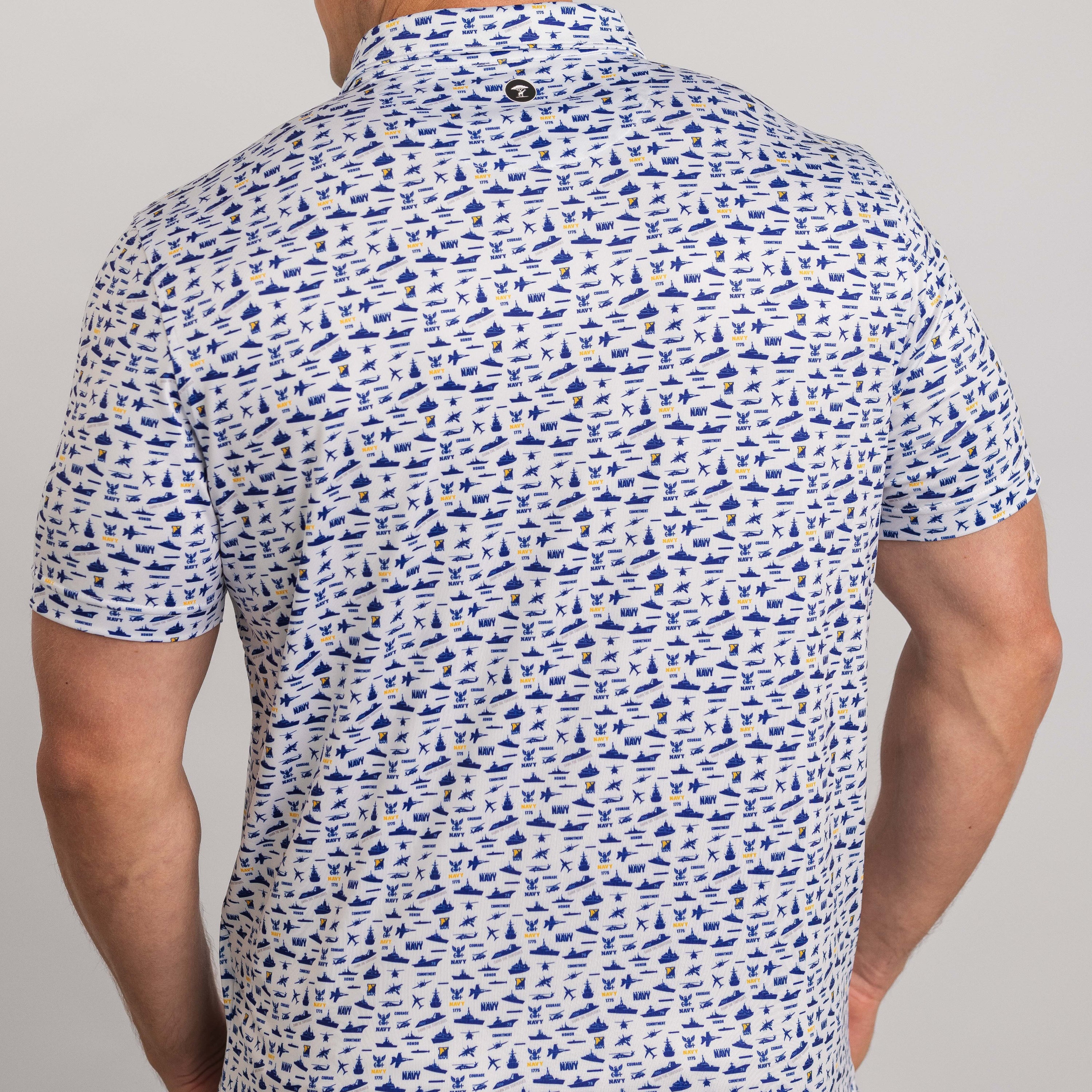 Man wearing a patterned short-sleeve shirt on a gray background
