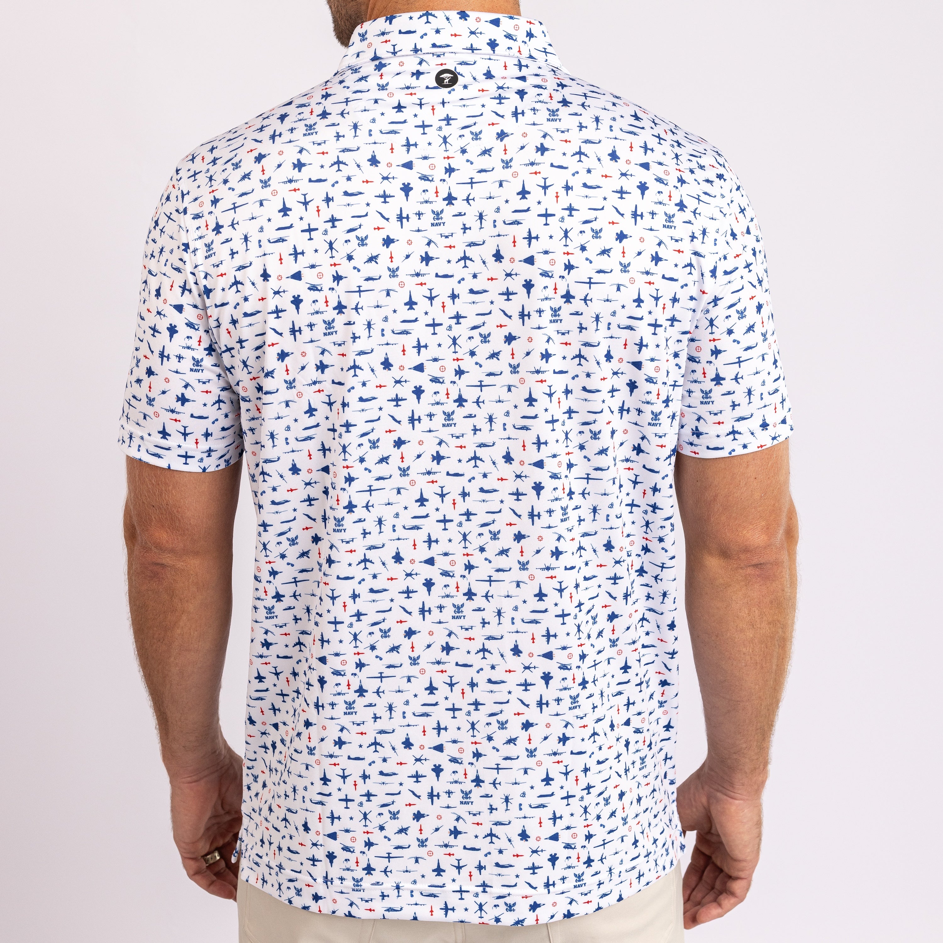 A man viewed from the back wearing a short-sleeve button-up shirt with an all-over nautical print