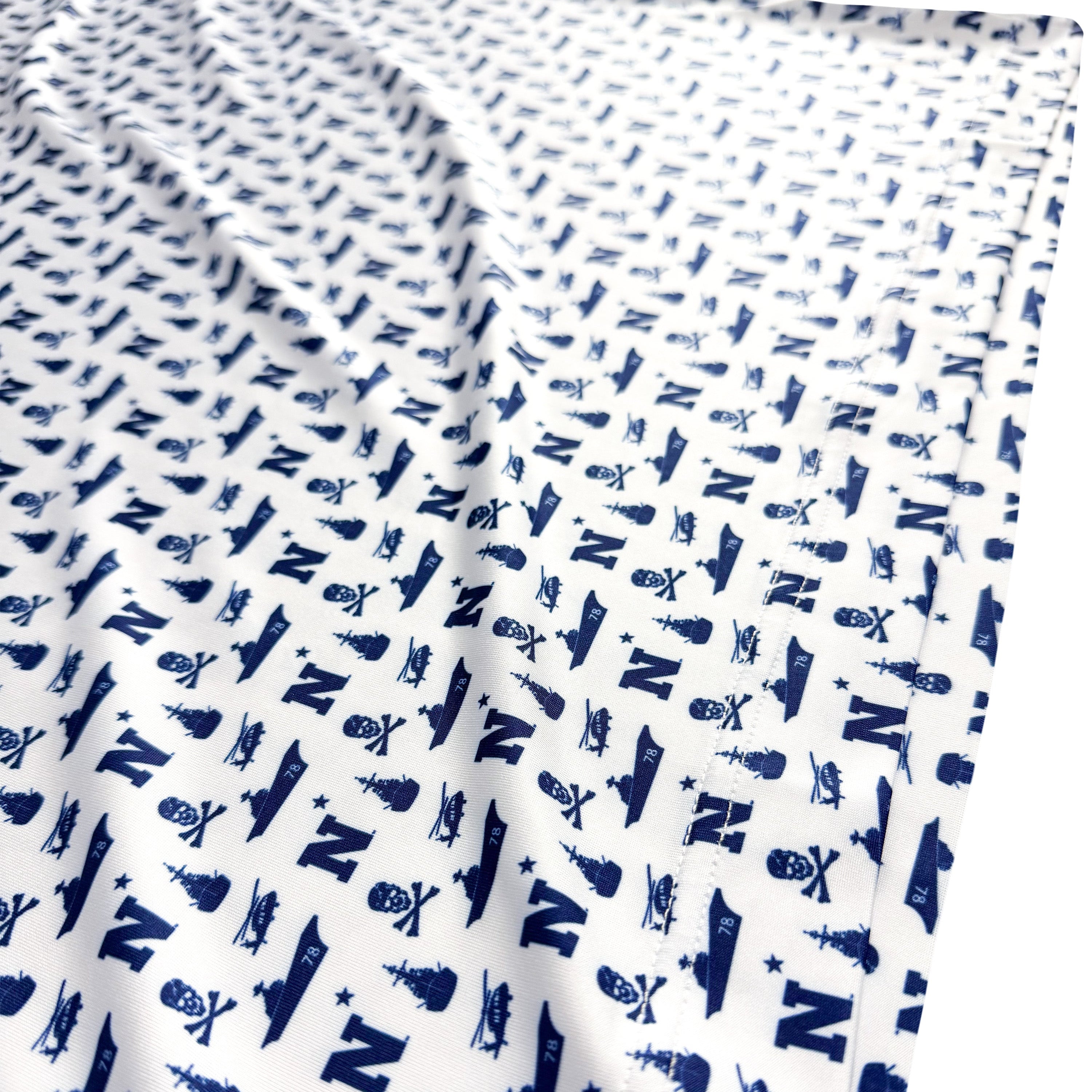 White fabric with blue letter 'N' pattern