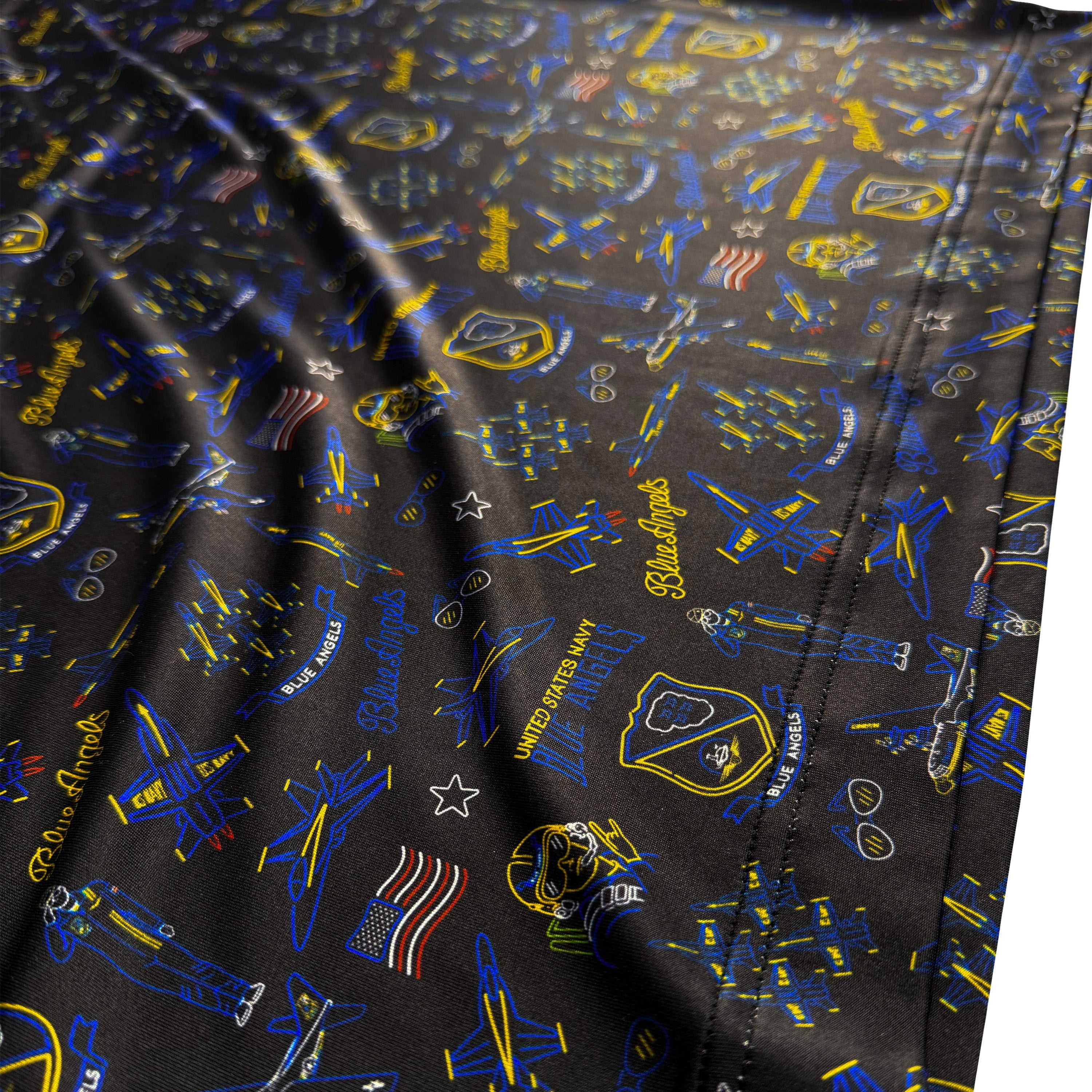 Close-up of a patterned fabric with blue and yellow designs on a black background