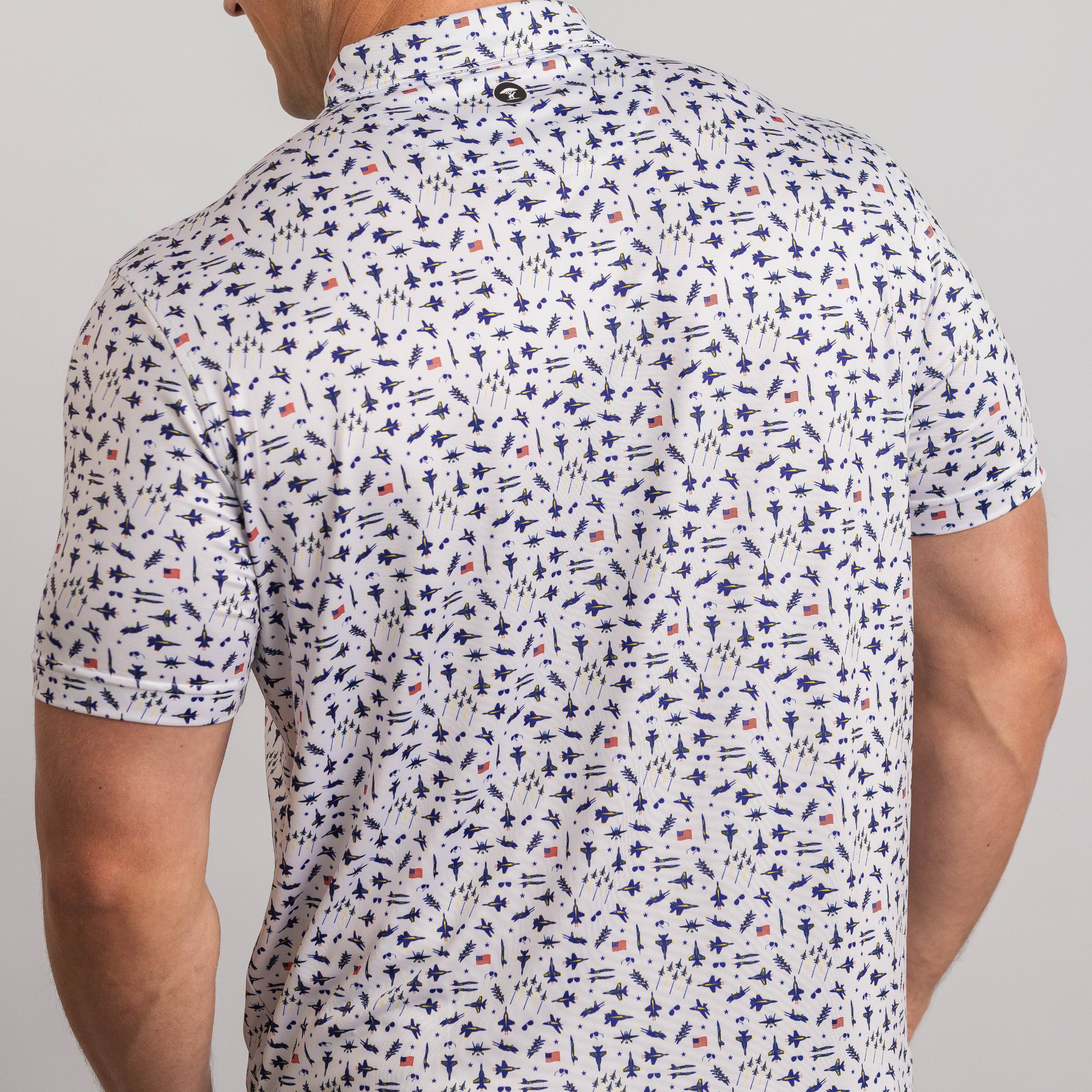 Man wearing a patterned short-sleeve shirt on a plain background