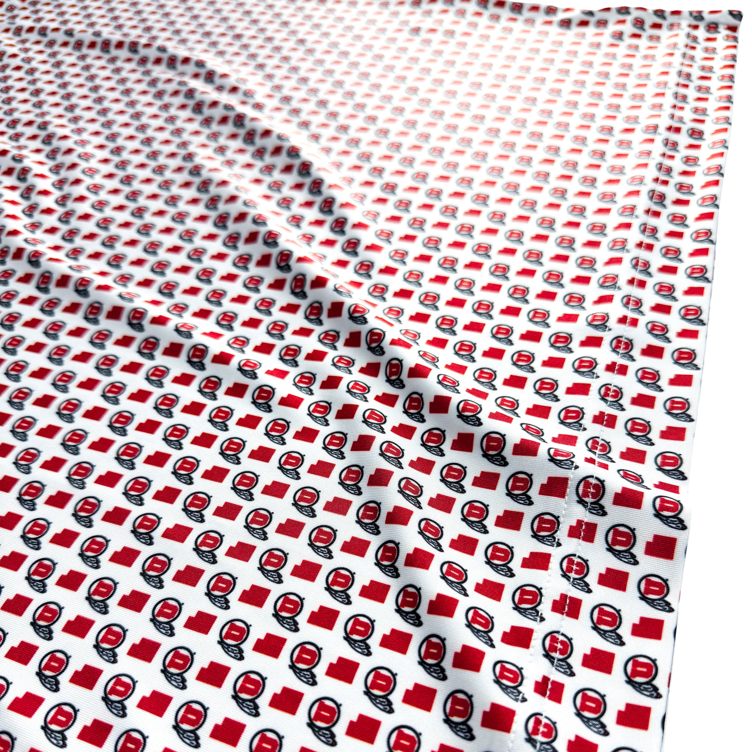 Fabric with a red and black pattern on a white background