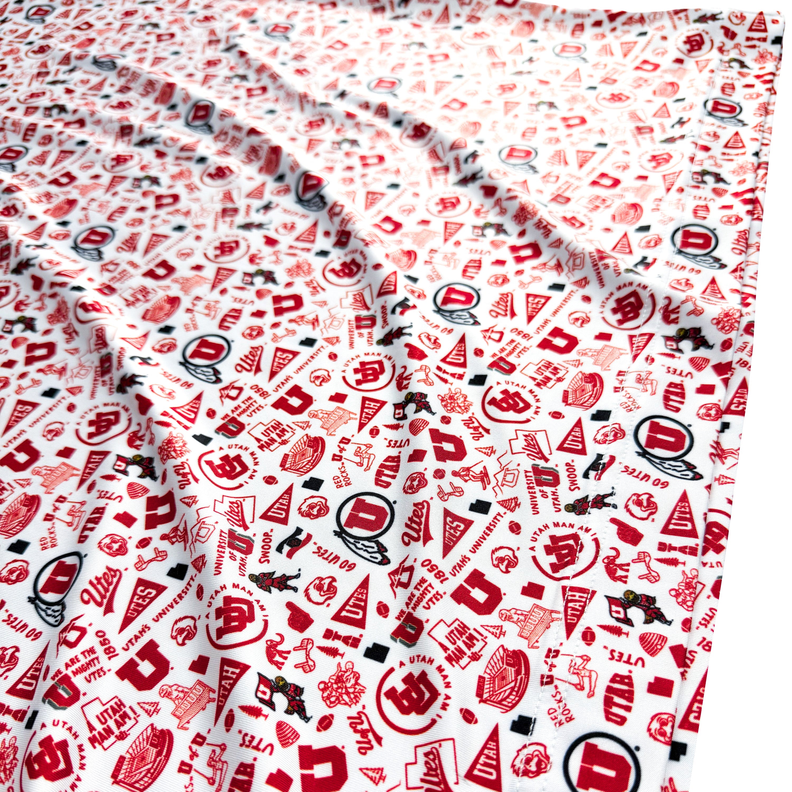 Patterned fabric with red and black designs on a white background